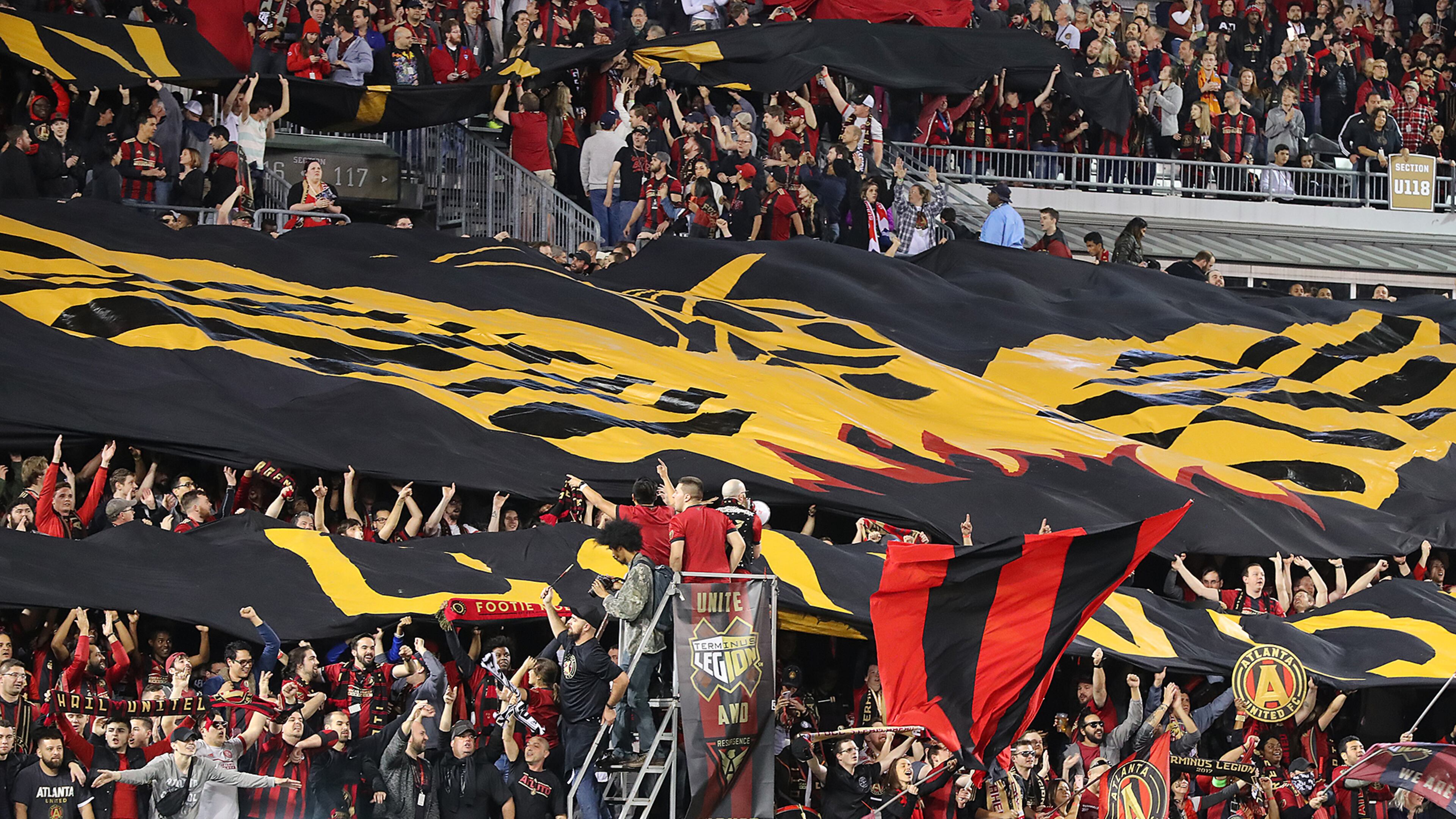 March 5, 2017, Atlanta: Fans unfurl the Atlanta United RC tifo to open the action against the N.Y. Red Bulls during their first game in franchise history on Sunday, March 5, 2017, in Atlanta. Curtis Compton/ccompton@ajc.com
