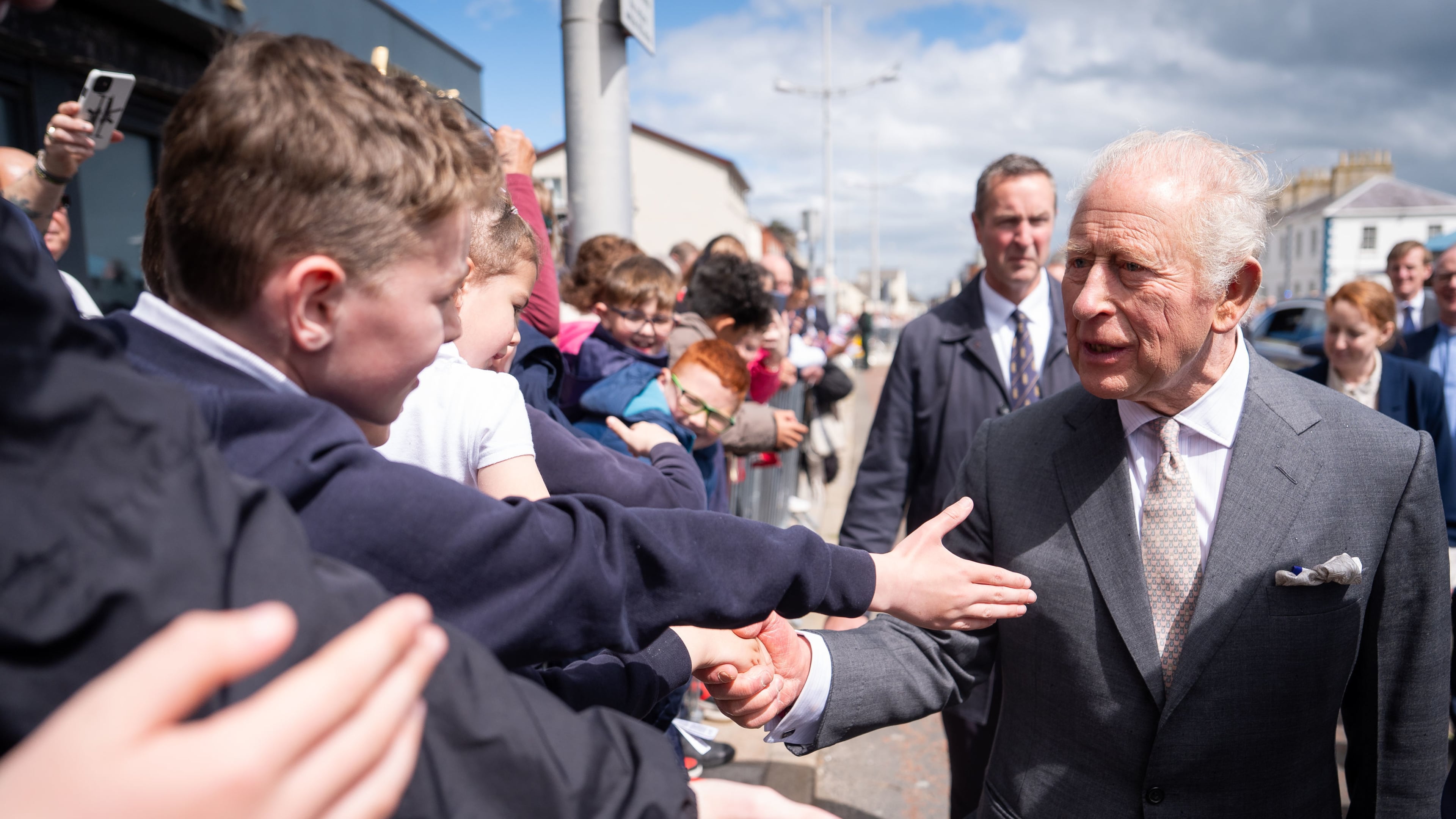 Britain's King Charles III, right, meets well-wishers outside The Pantry Foodbank in Donard Methodist Church, Newcastle, Northern Ireland, Wednesday, May 20, 2026. (Aaron Chown/PA via AP)