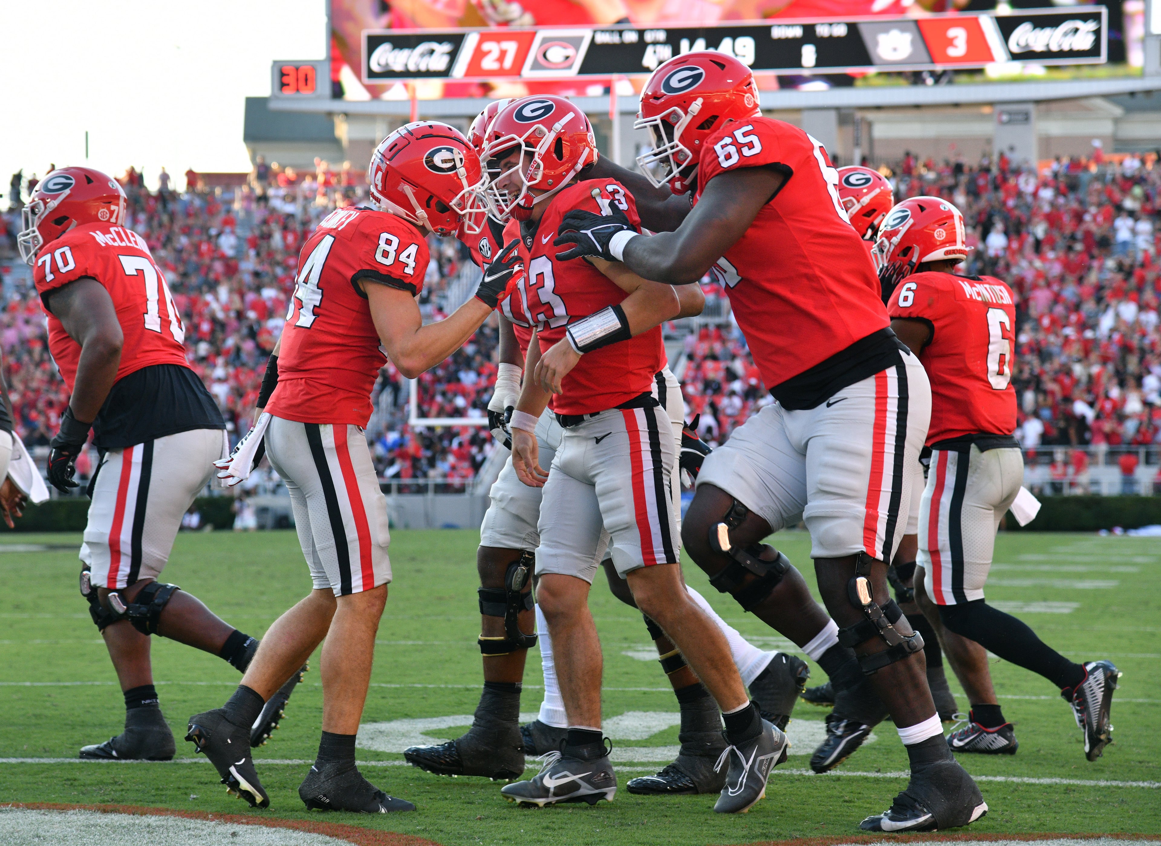 Georgia's quarterback Stetson Bennett (13) is congratulated by teammates after he scored a touchdown during the second half in a NCAA college football game at Sanford Stadium in Athens on Saturday, October 8, 2022. Georgia won 42-10 over Auburn. (Hyosub Shin / Hyosub.Shin@ajc.com)