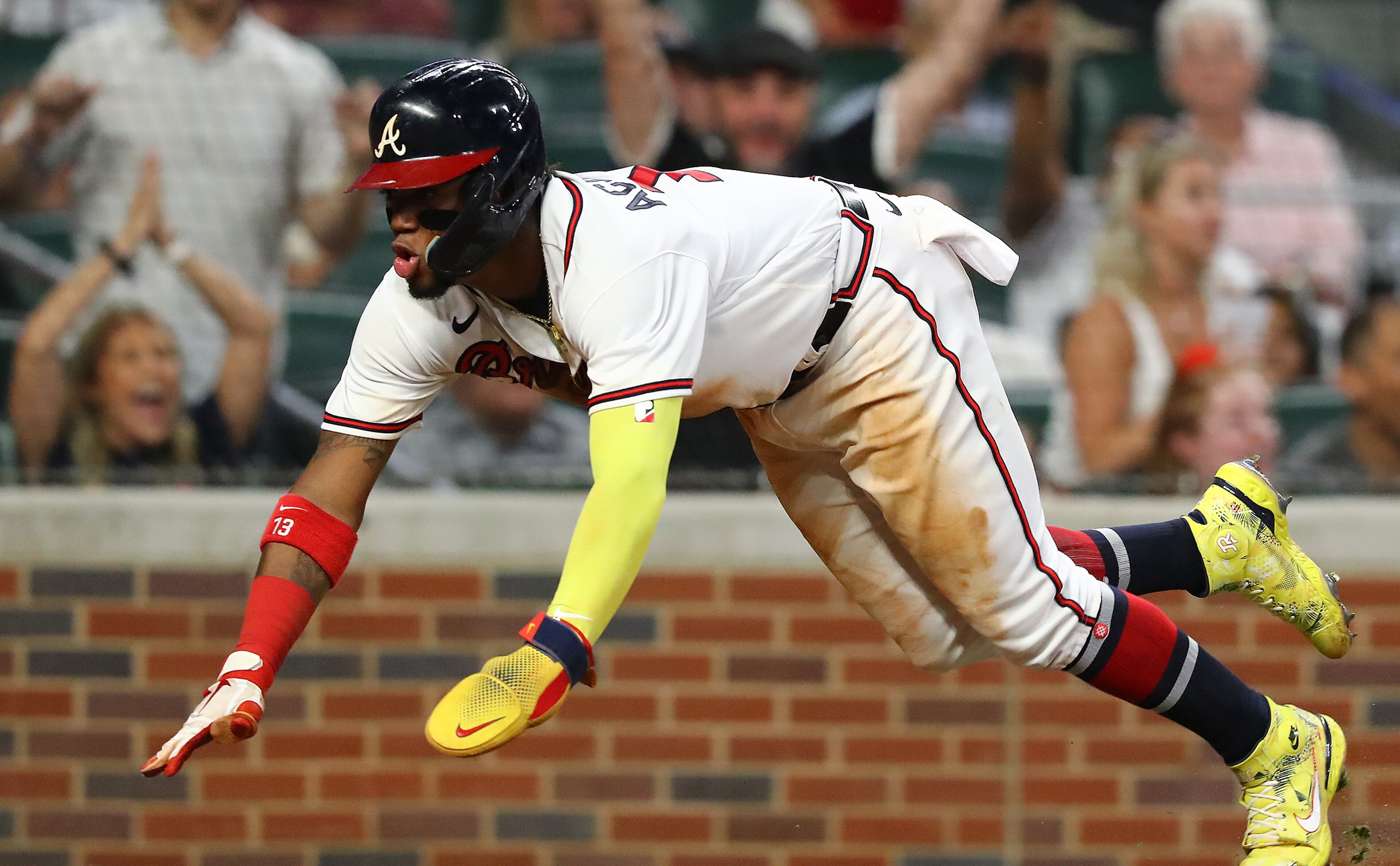 Braves outfielder Ronald Acuna slides home to score all the way from first base on a RBI-single by Dansby Swanson for a 4-0 lead over the New York Mets during the seventh inning in a MLB baseball game on Tuesday, August 16, 2022, in Atlanta. Acuna scored after drawing his fourth base on balls in the game. “Curtis Compton / Curtis Compton@ajc.com