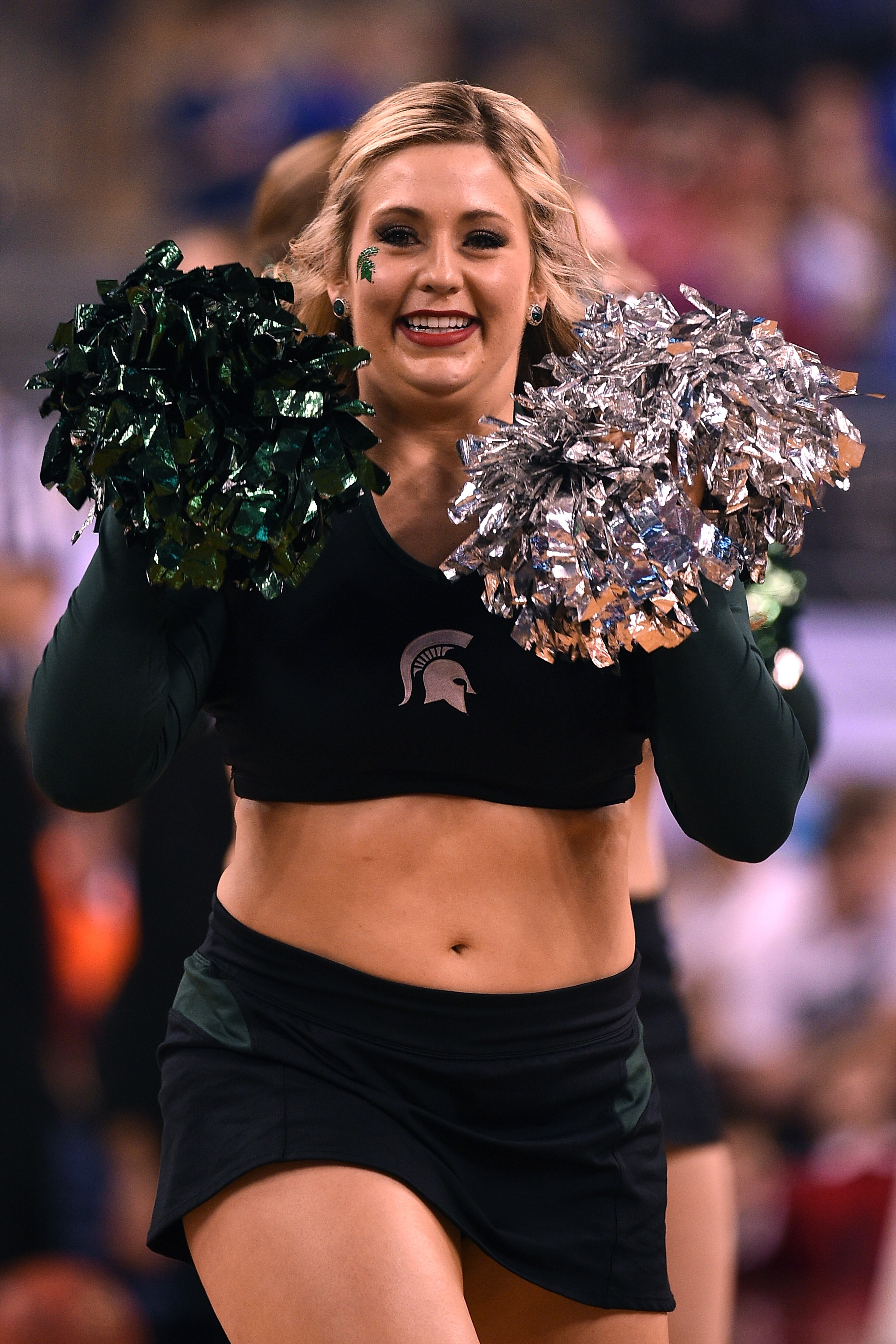 INDIANAPOLIS, IN - APRIL 04: A cheerleader of the Michigan State Spartans performs against the Duke Blue Devils during the NCAA Men's Final Four Semifinal at Lucas Oil Stadium on April 4, 2015 in Indianapolis, Indiana. Duke won 81-61. (Photo by Lance King/Getty Images)