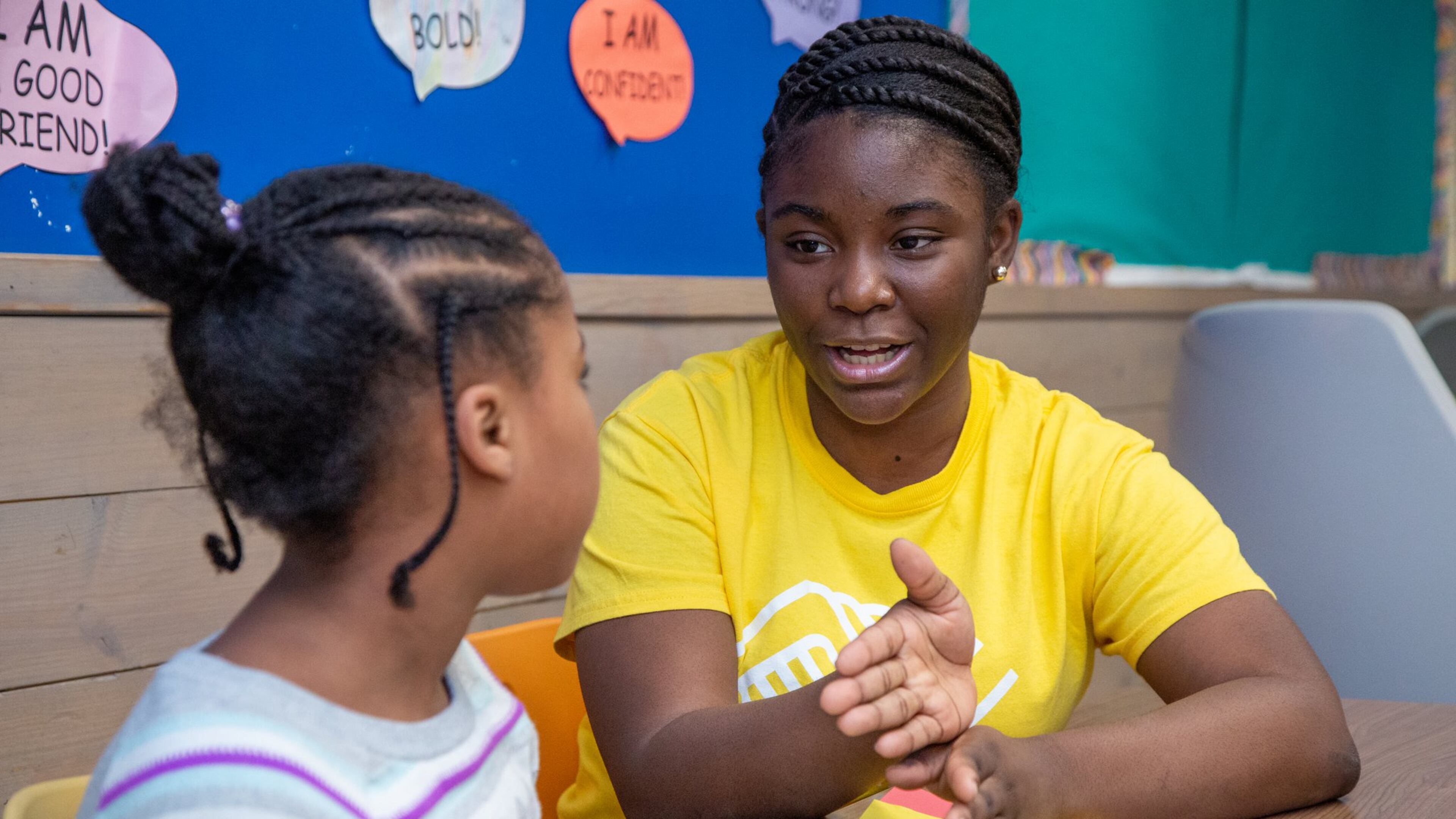 Kimberly Heard (right) helps 8-year-old Brooklyn DeBerry with homework at the A.R. “Gus” Barksdale Boys & Girls Club in Conyers. She was given the Boys & Girls Clubs of Metro Atlanta’s most prestigious award - 2019/2020 Youth of the Year. She advocates for underserved teens and helps them overcome obstacles. (Photo by Phil Skinner)