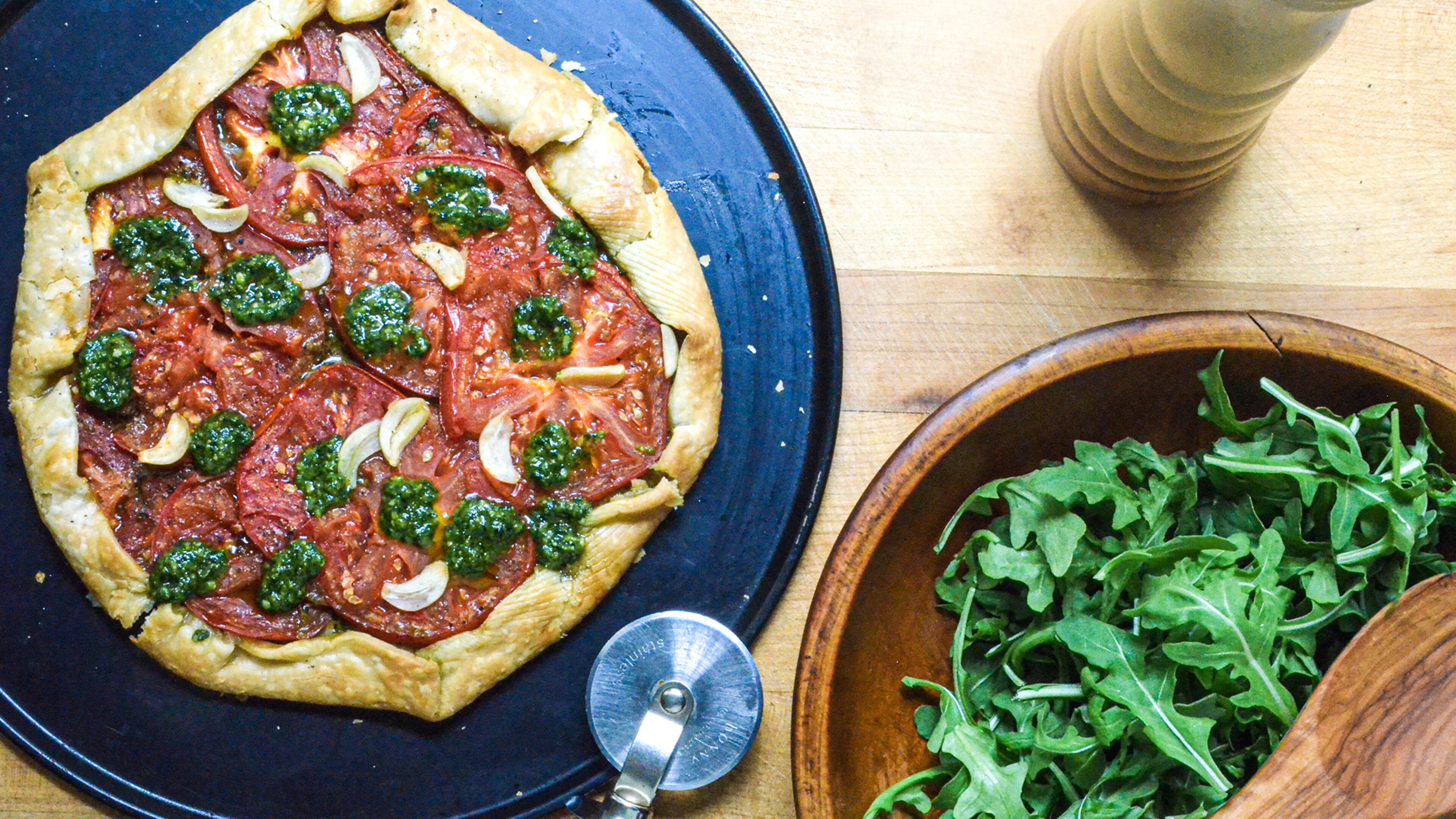 A simple galette made with sliced tomatoes and store-bought pesto celebrates summer.
(Virginia Willis for The Atlanta Journal-Constitution)