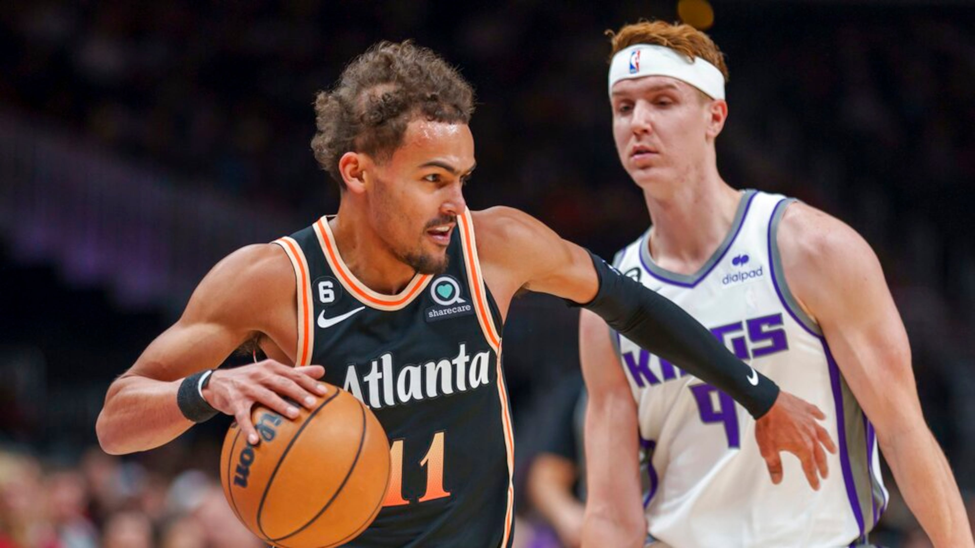 Atlanta Hawks guard Trae Young (11) drives against Sacramento Kings guard Kevin Huerter (9) during the first half of an NBA basketball game on Wednesday, Nov. 23, 2022, in Atlanta. (AP Photo/Erik Rank)