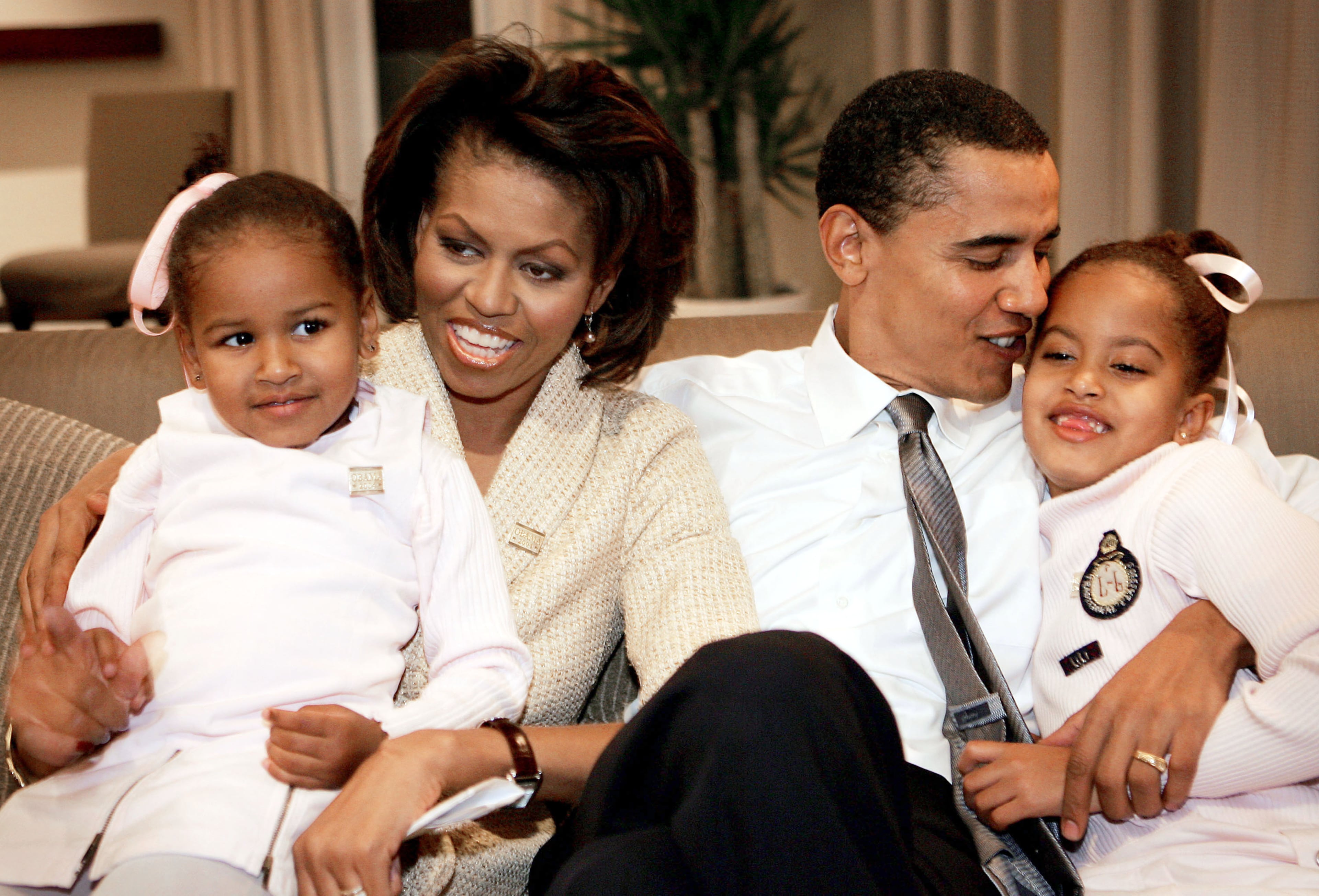 Candidate for the U.S. Senate Barack Obama (D-IL) sits with his wife Michelle and daughters Sasha (L) and Malia (R) in a hotel room as they wait for election returns to come in November 2, 2004 in Chicago, Illinois. Obama is expected to win easily against the Republican candidate Alan Keyes. (Photo by Scott Olson/Getty Images)