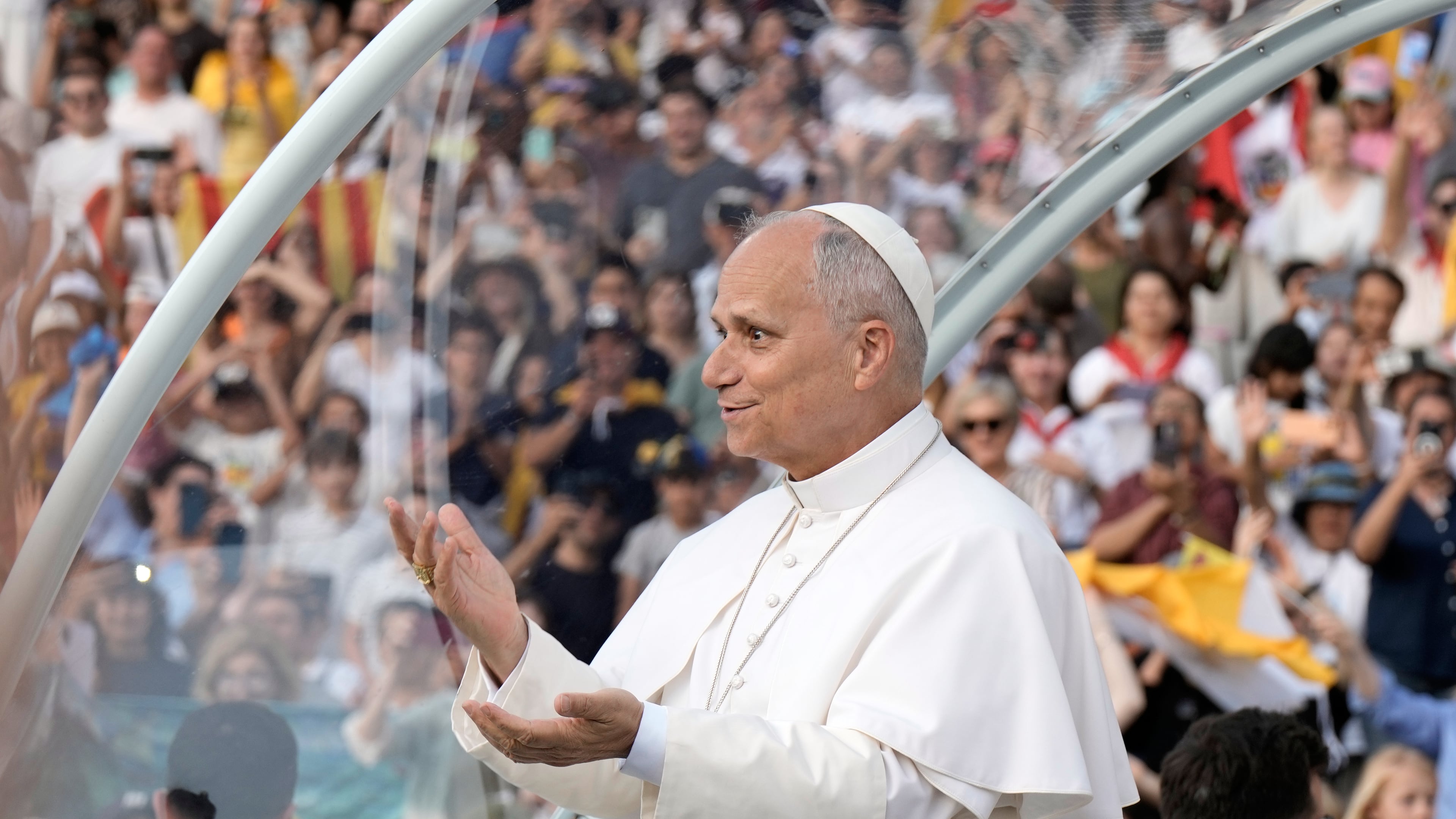 Pope Leo XIV makes a six-seven hand gestures as he arrives to attend a prayer vigil at Lluis Companys Olympic Stadium in Barcelona, Spain, Tuesday, June 9, 2026. (AP Photo/Bernat Armangue)