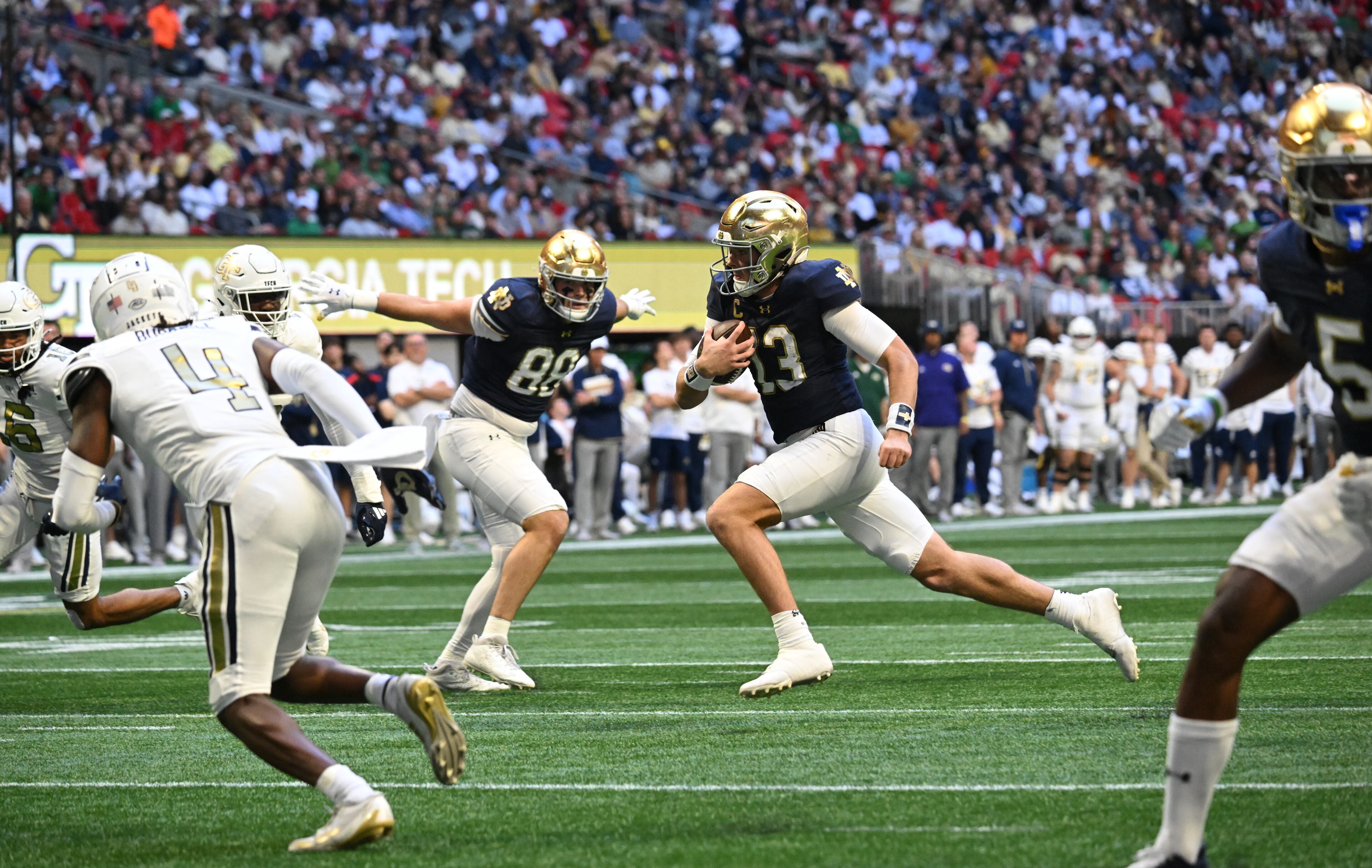 Notre Dame quarterback Riley Leonard (13) runs for a touchdown during the first half in an NCAA football game at Mercedes-Benz Stadium, Saturday, October 19, 2024, in Atlanta. Notre Dame won 31-13 over Georgia Tech. (Hyosub Shin / AJC)