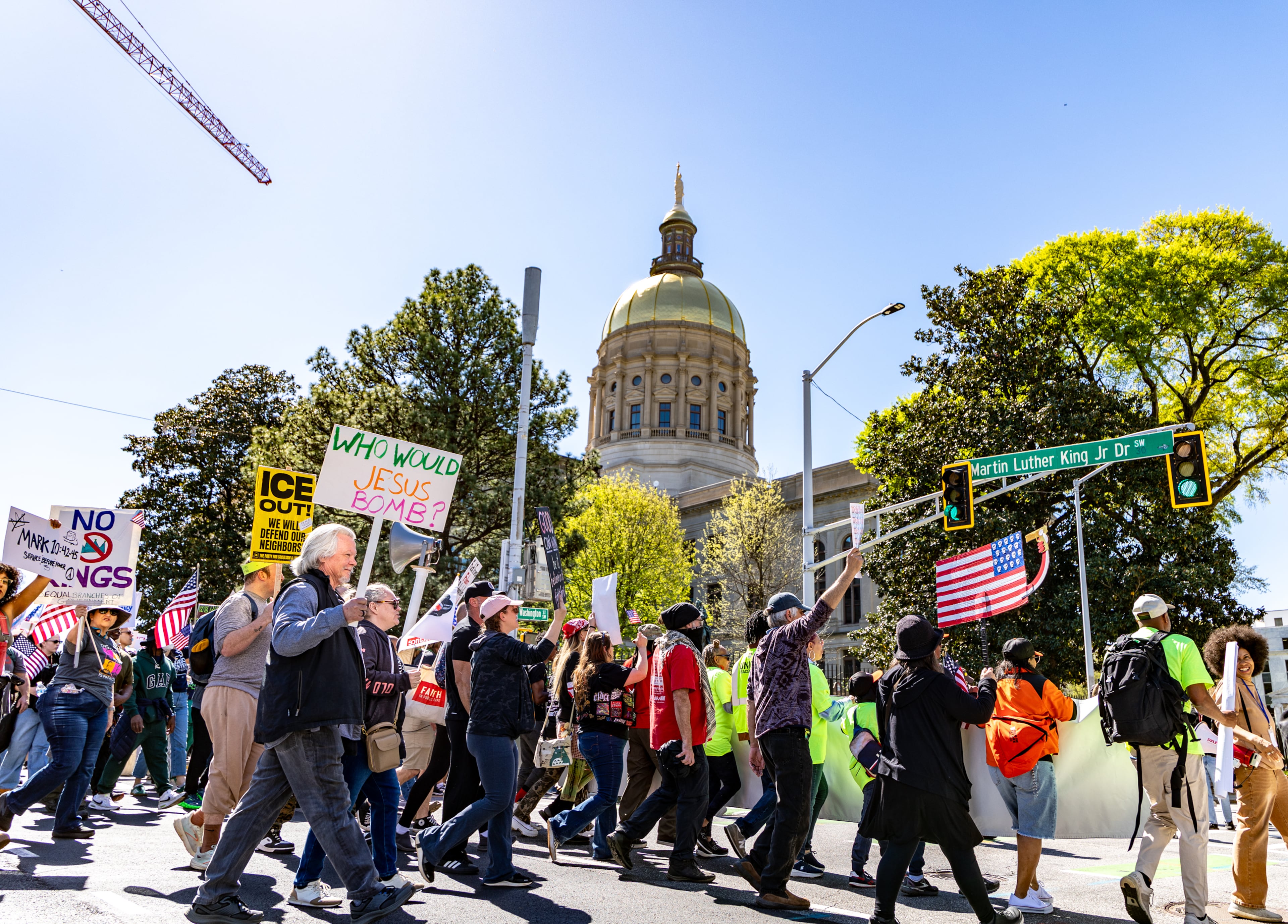 Demonstrators march around the state Capitol during the No Kings protest on Saturday, March 28, 2026, in Atlanta. (Jenni Girtman for the AJC)