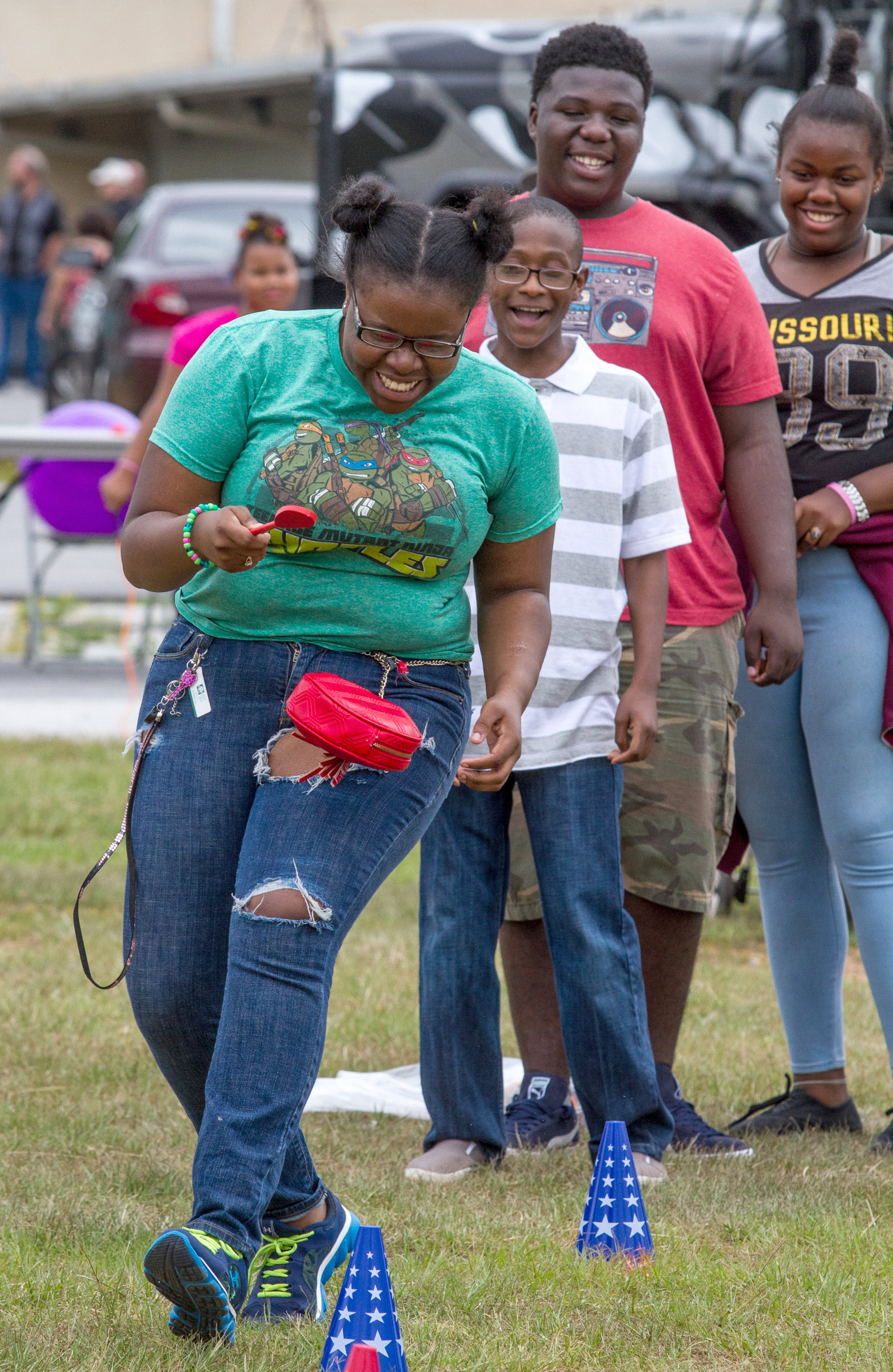 Mahogany Greene, from team Mustang, makes her way through the Egg Spoon Race at the Lift Up Summer Fun Festival on Saturday, June 18, 2016, in Lawrenceville, Ga. To enter in the competition, teams donated school supplies that will go to homeless and low-income families. STEVE SCHAEFER / SPECIAL TO THE AJC