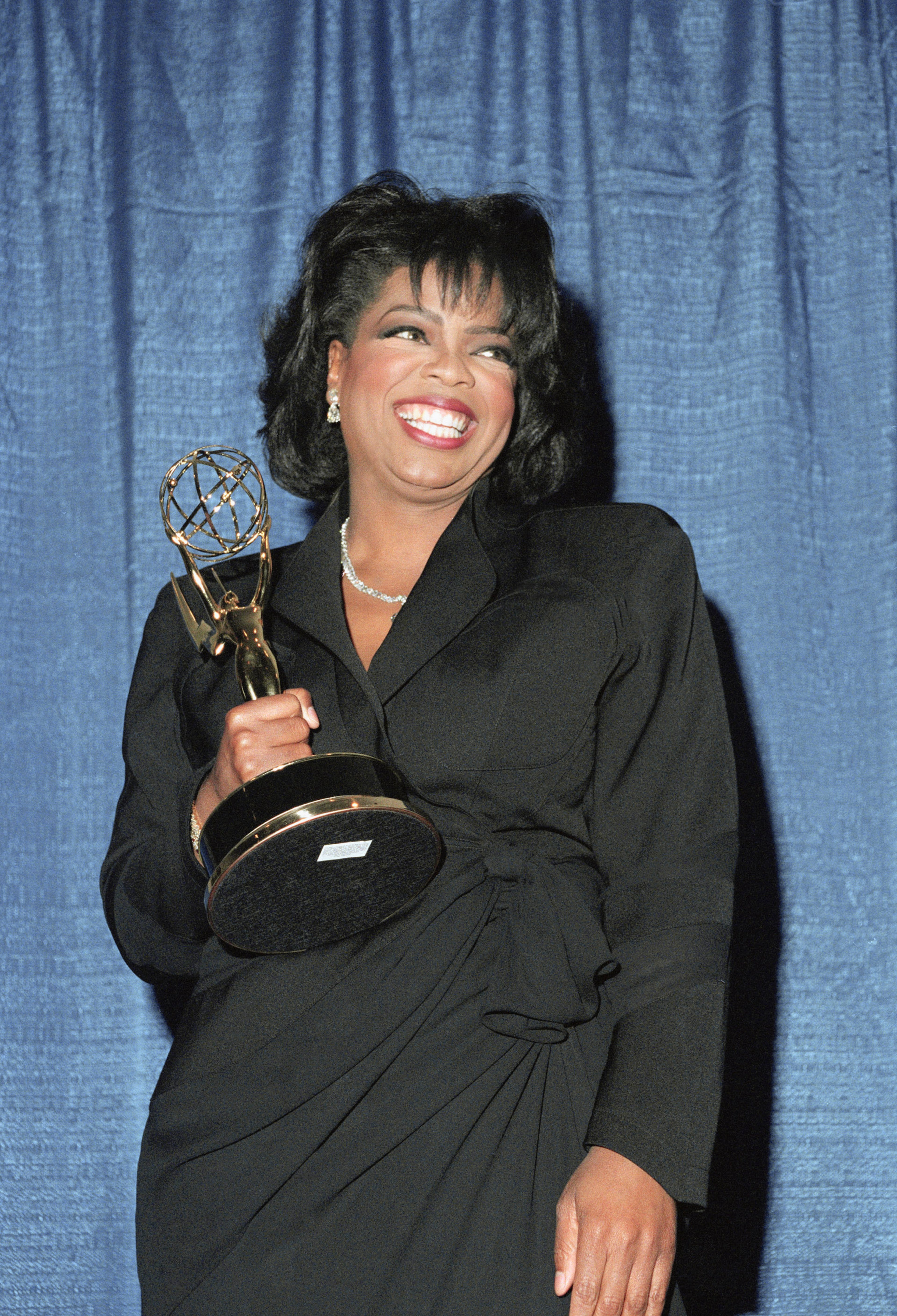 Television Star Oprah Winfrey smiles with her award at the Annual Daytime Emmy Awards, Wednesday, May 26, 1993, New York. Winfrey beat Phil Donahue, Joan Rivers, Regis Philbin and Kathie Lee Gifford, and Vicki Lawrence for best talk show host. (AP Photo/Paul Hurshman)