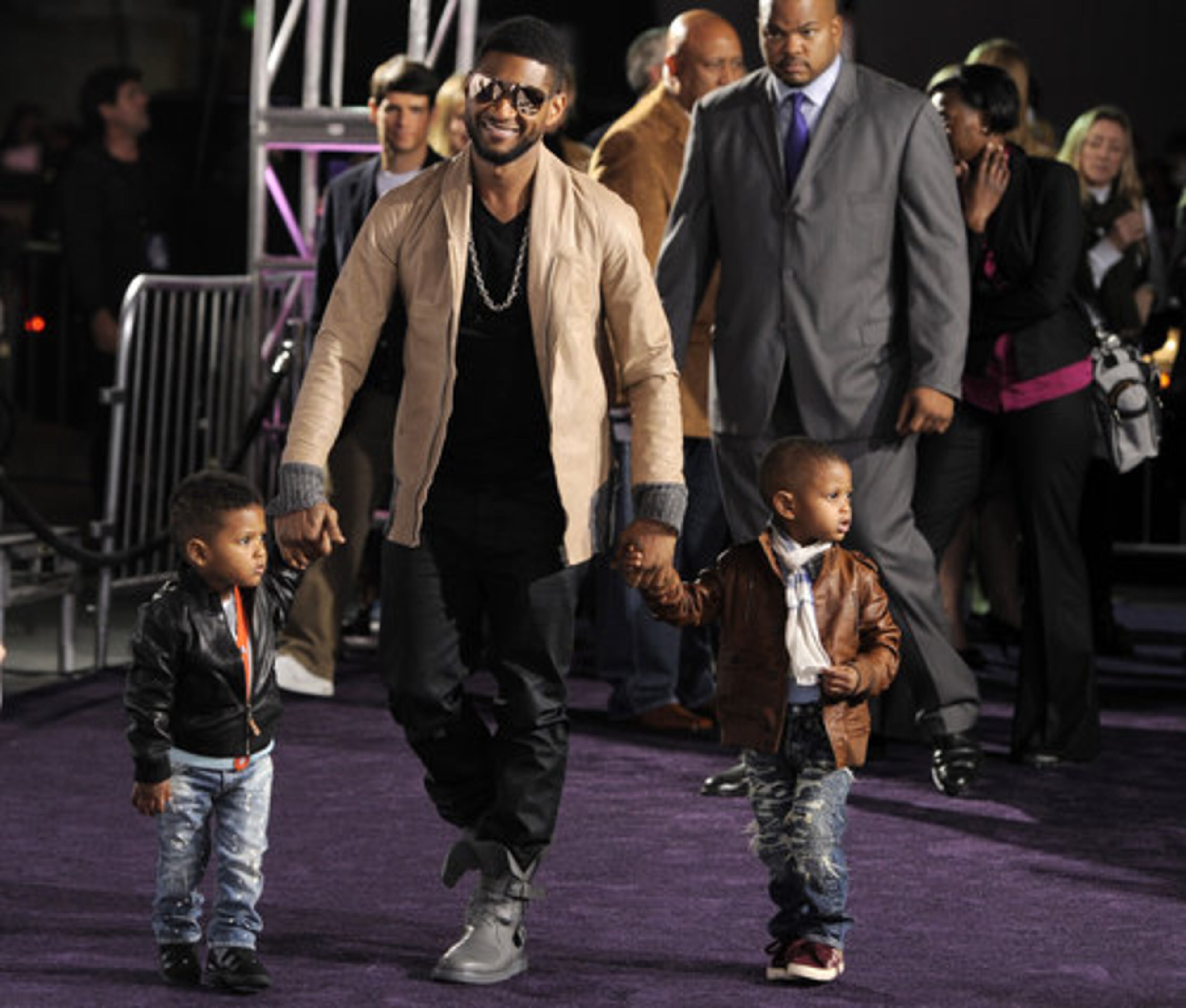 The next generation's Biebers: Usher arrives at the premiere with his two young sons in tow.