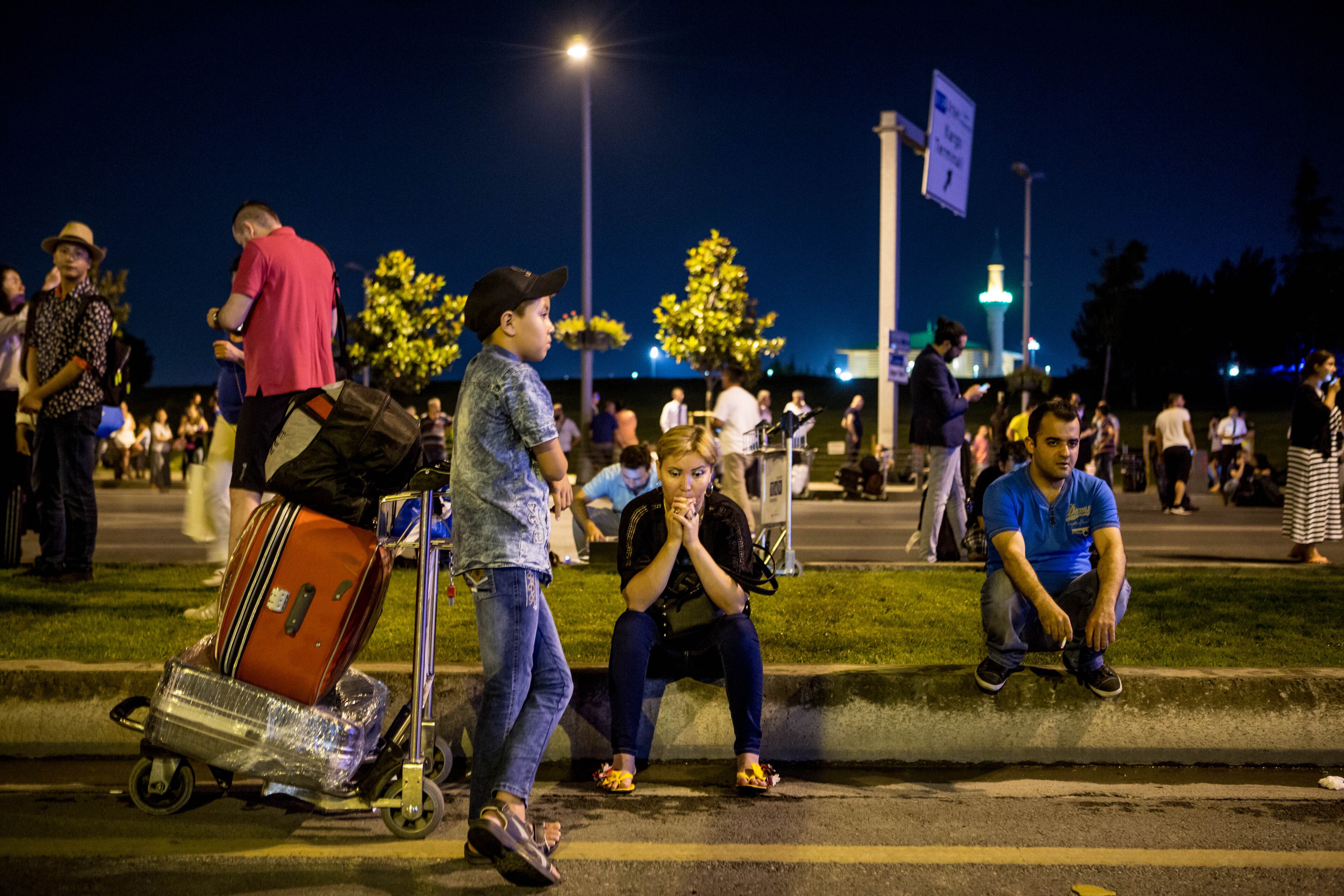 Passengers leave Istanbul Ataturk, Turkey's largest airport, after a suicide bomb attack in the early hours of June 29, 2016. Three suicide bombers opened fire before blowing themselves up at the entrance to the main international airport in Istanbul, killing at least 28 people and wounding at least 60 people according to Istanbul governor Vasip Sahin. (Photo by Defne Karadeniz/Getty Images)