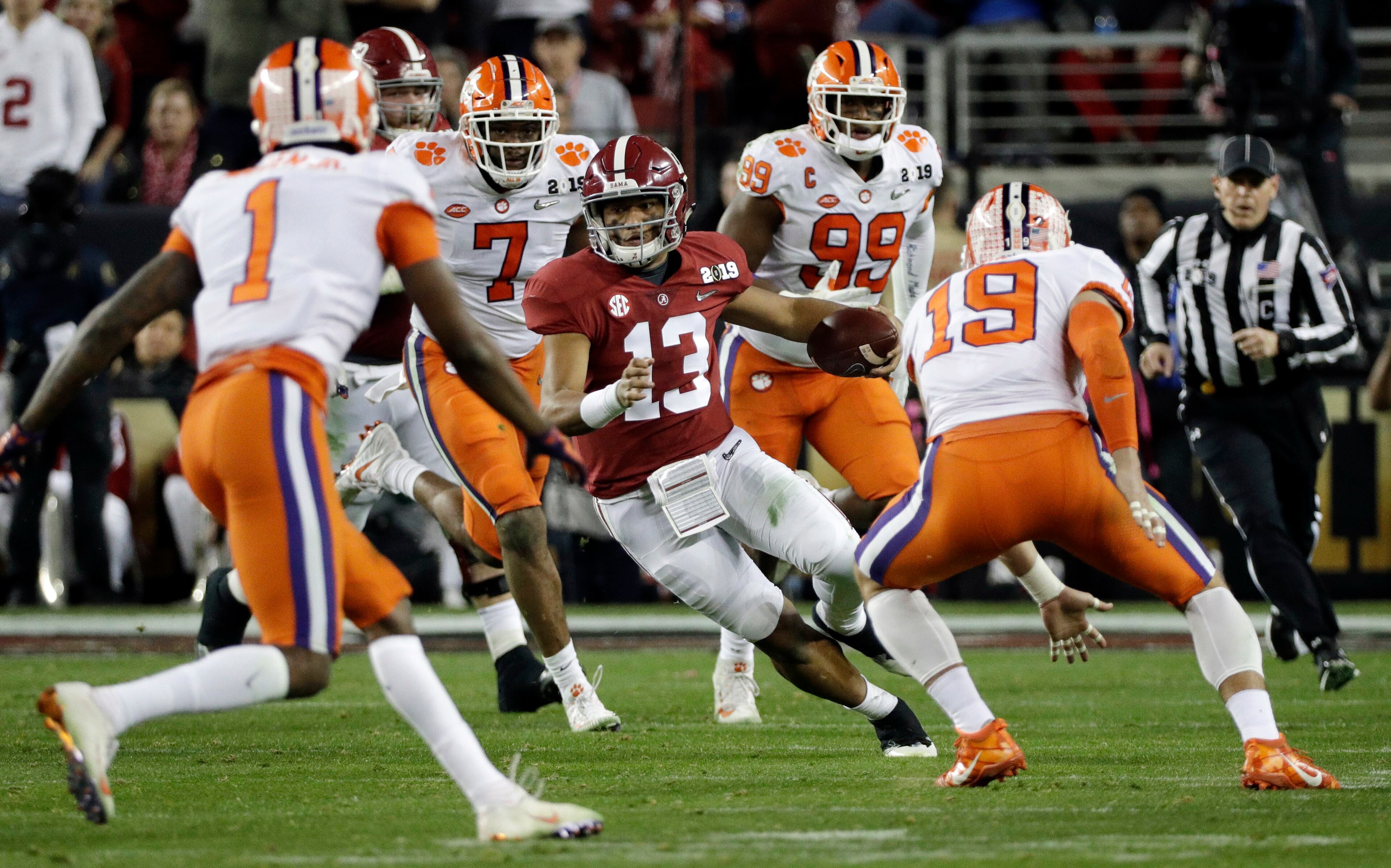 Alabama's Tua Tagovailoa scrambles during the first half of the NCAA college football playoff championship game against Clemson, Monday, Jan. 7, 2019, in Santa Clara, Calif.
