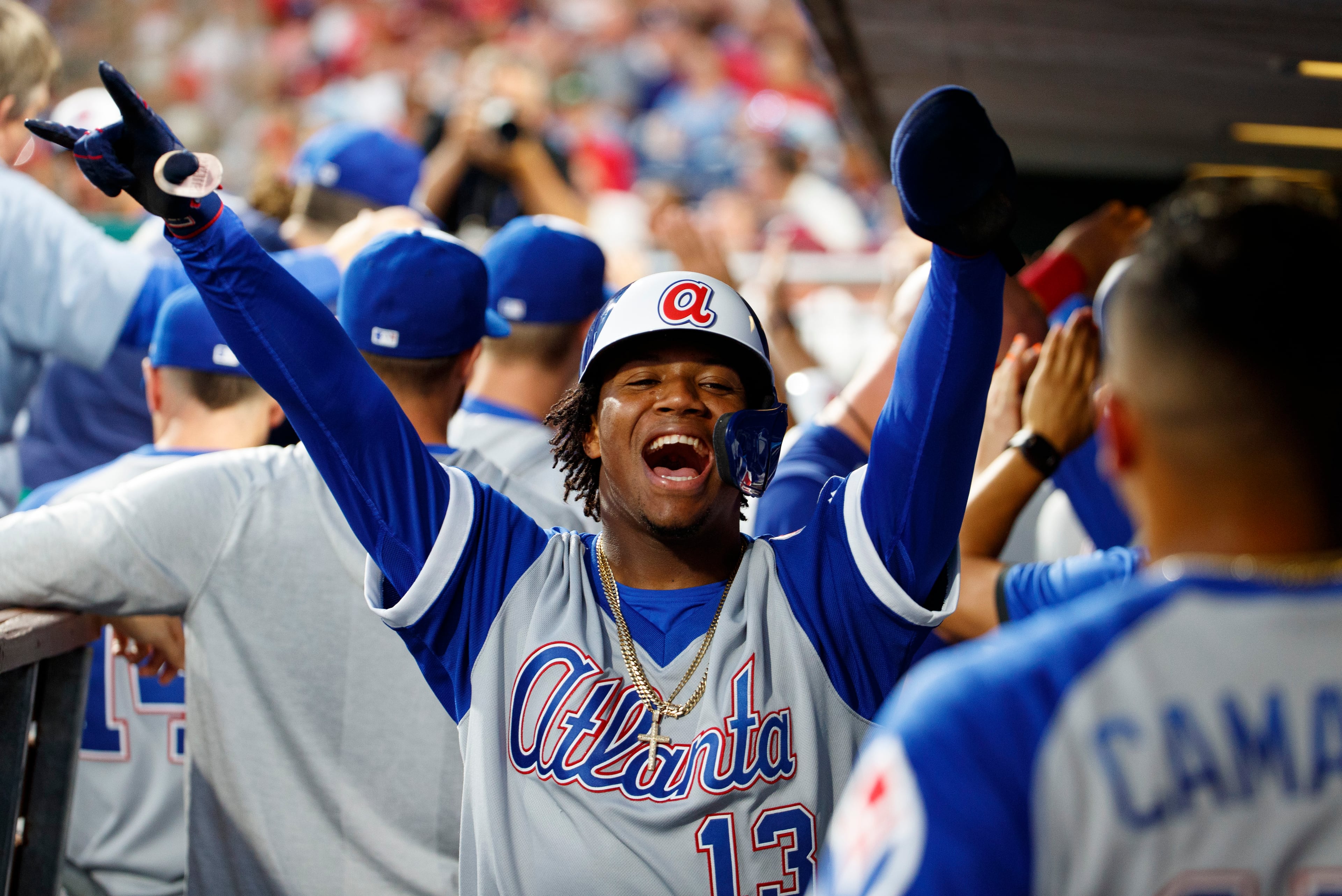 Atlanta Braves' Ronald Acuna Jr. reacts to scoring on the grand slam by Ozzie Albies during the third inning of a baseball game against the Philadelphia Phillies, Saturday, July 27, 2019, in Philadelphia. (AP Photo/Chris Szagola)