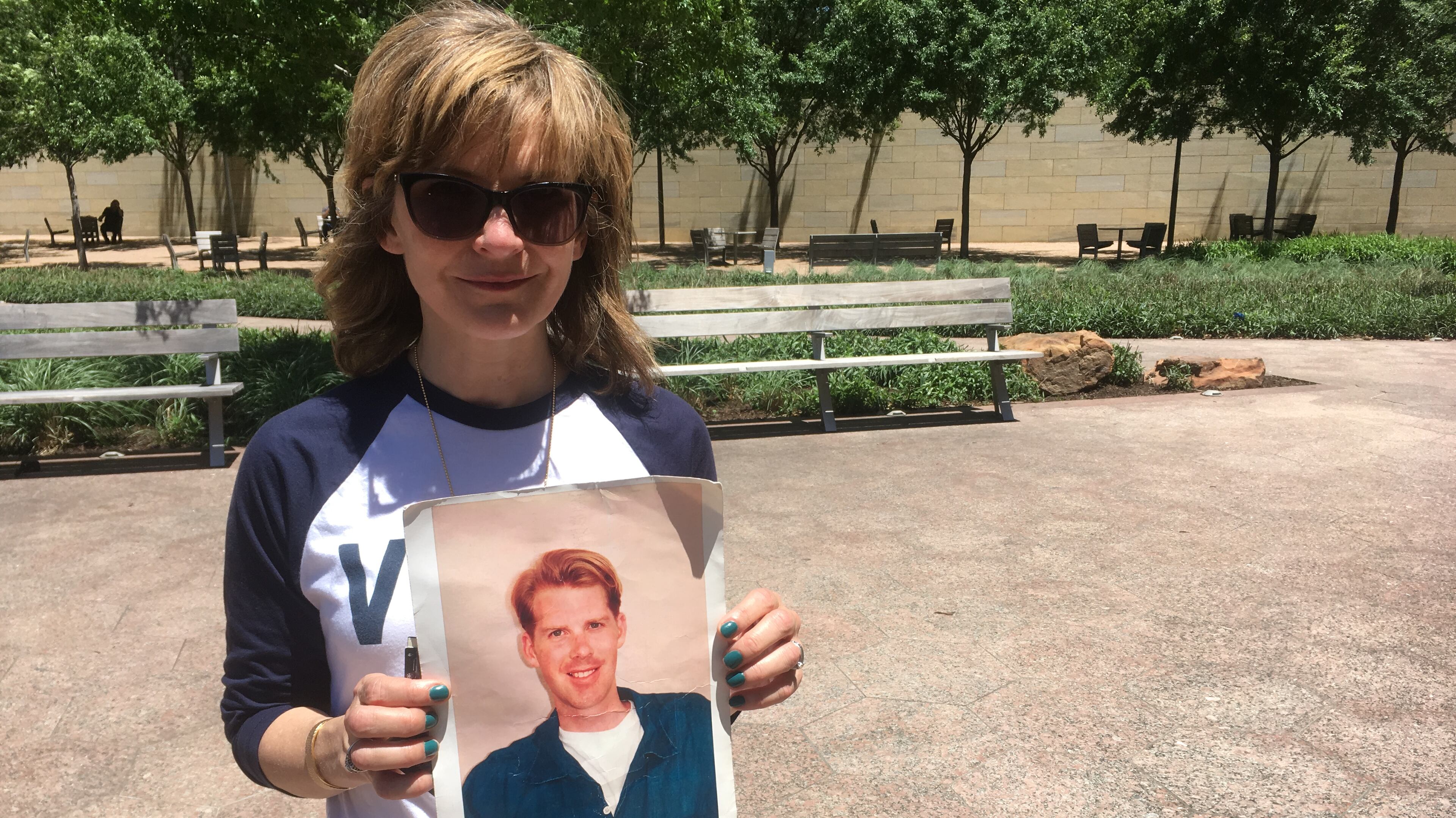 Kim Russell with a photo of her friend Philip Rau, who was shot to death in Inman Park in 1999, at a Dallas rally protesting the NRA's political clout. Photo: Jennifer Brett, jbrett@ajc.com