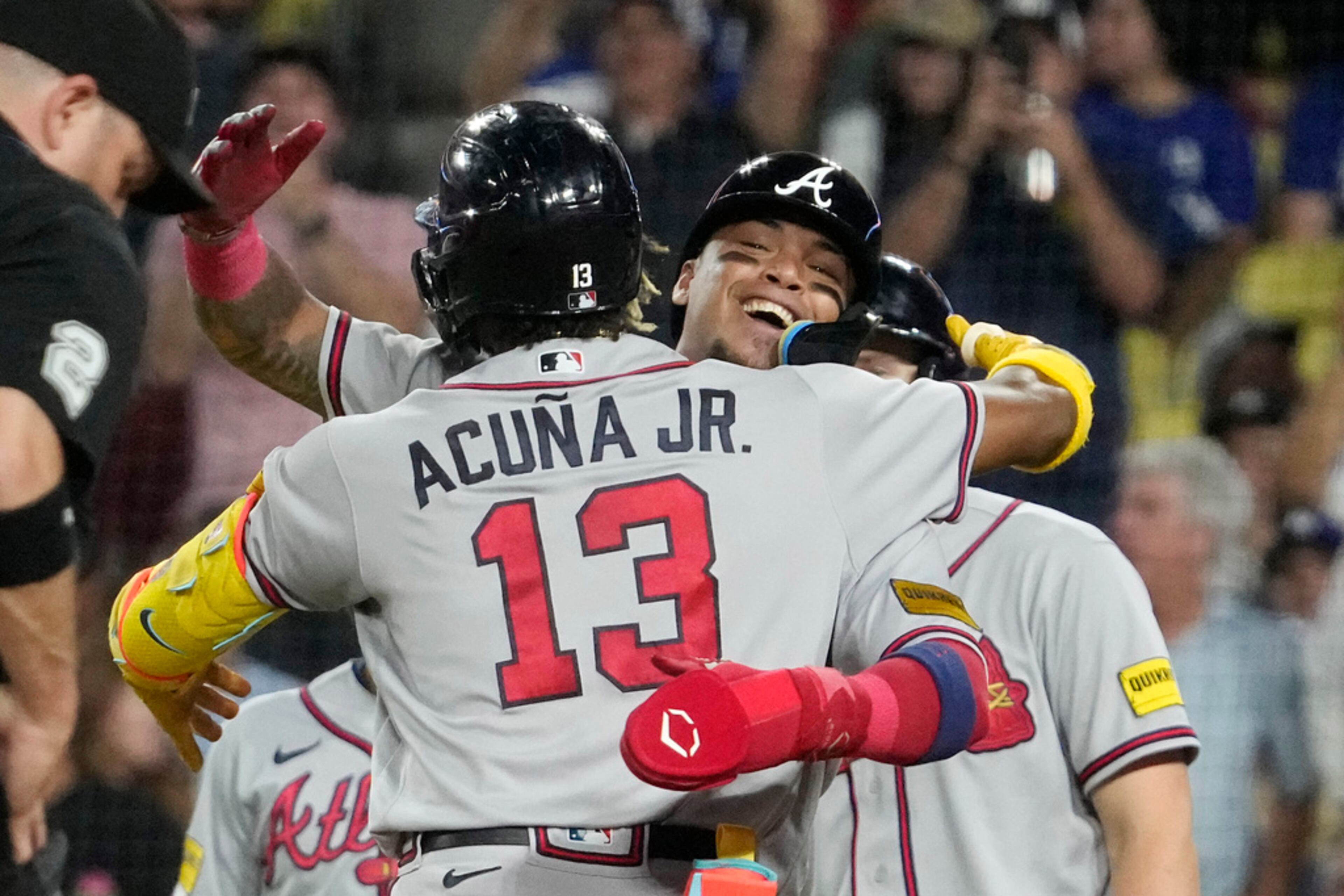 Atlanta Braves' Ronald Acuna Jr., left, celebrates with Orlando Arcia after hitting a grand slam during the second inning of a baseball game against the Los Angeles Dodgers Thursday, Aug. 31, 2023, in Los Angeles. (AP Photo/Mark J. Terrill)