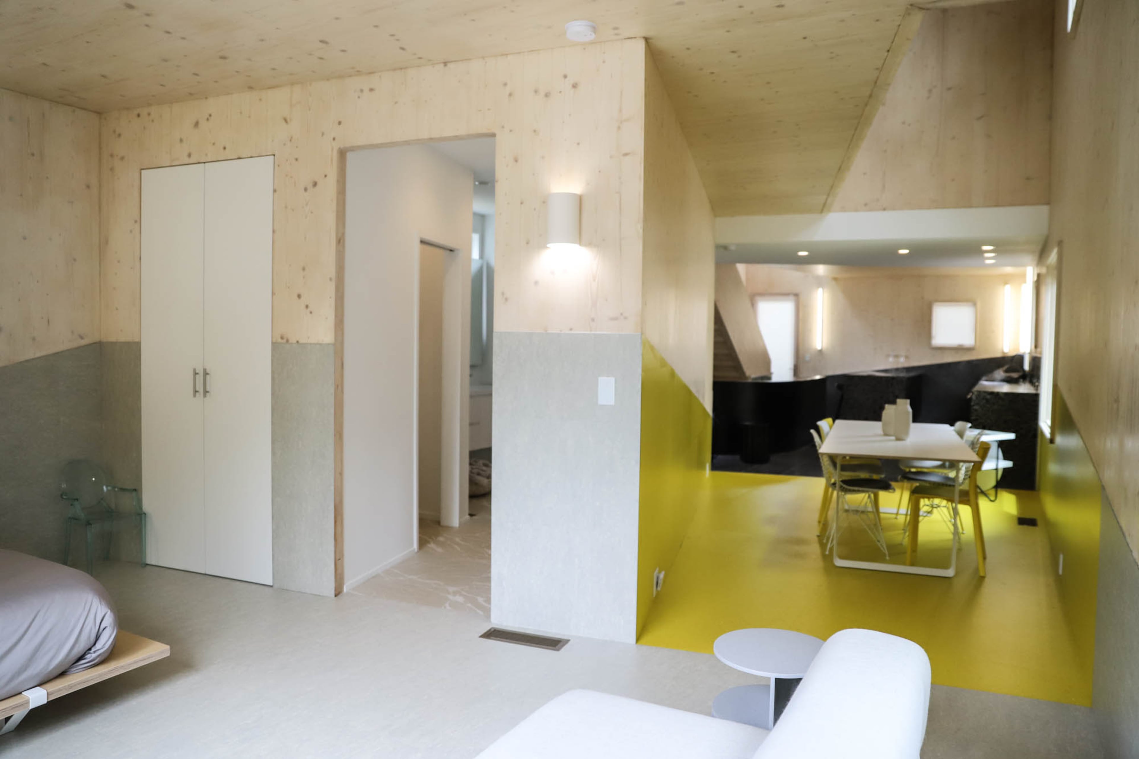 Unconventional materials with faux finishes are used throughout the Atlanta home, such as vinyl tile from Forbo Flooring Systems and Johnsonite. The cross-laminated timber panels are by KLH USA.