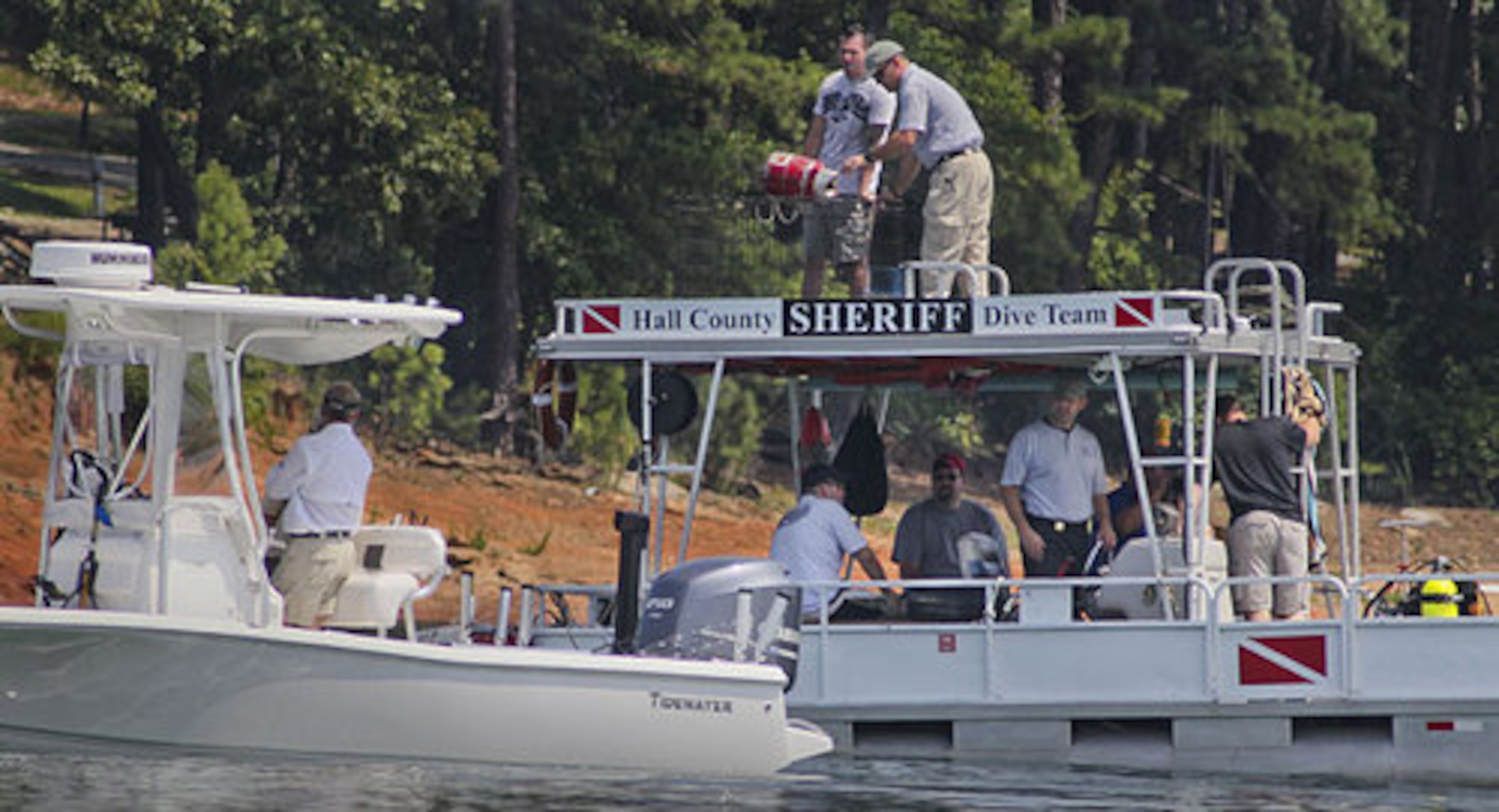 Dive teams from Forsyth and Hall counties searched from the pontoon boat. The driver of a boat believed to have been involved in a fatal hit-and-run collision that left a 9-year-old boy dead and his 13-year-old brother missing for nine days in the murky waters of Lake Lanier faces possible homicide charges.