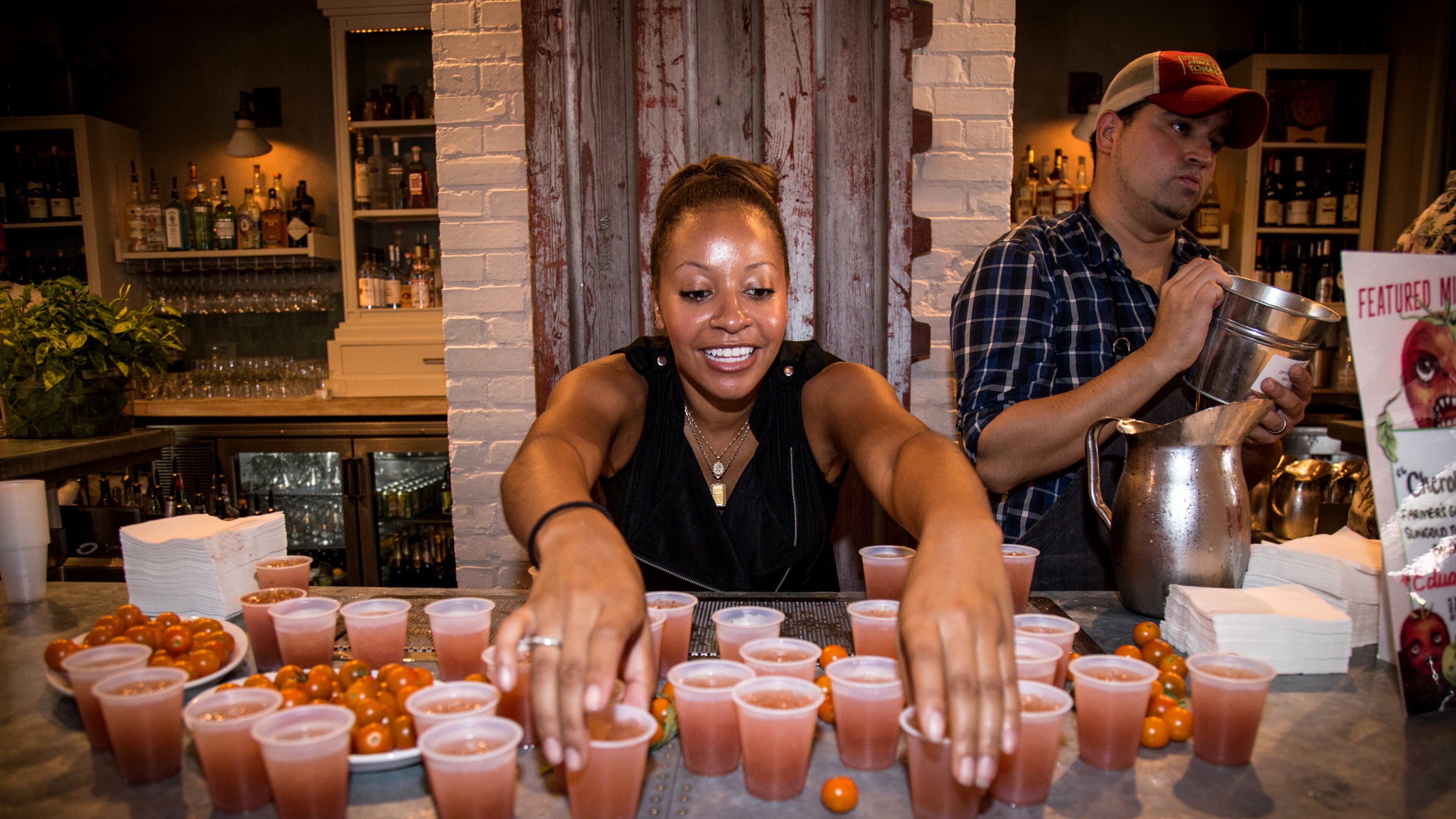 Kesha Bellamy sets out Cherokee Purple cocktails at JCT Kitchen and Bar during the 7th annual Attack of the Killer Tomato Festival at JCT Kitchen and Bar in Atlanta, Ga. Sunday July 19th.STEVE SCHAEFER / SPECIAL TO THE AJC