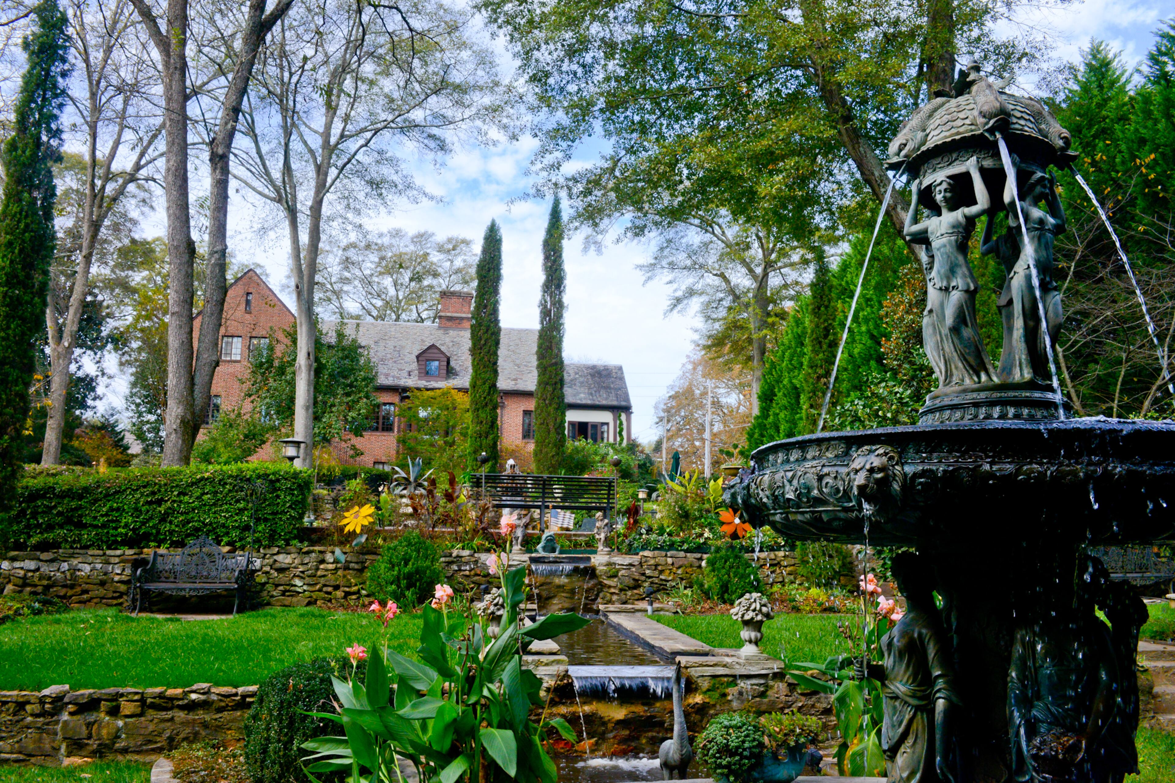 When Keenan Nix began clearing the overgrown jungle on his East Lake property, he discovered four stonewalled terraces, which inspired his English garden. Fountains, planters and sculptures, primarily from JAM'n Designs and Intown Ace Garden Center surround a waterfall that cascades down the terraces.