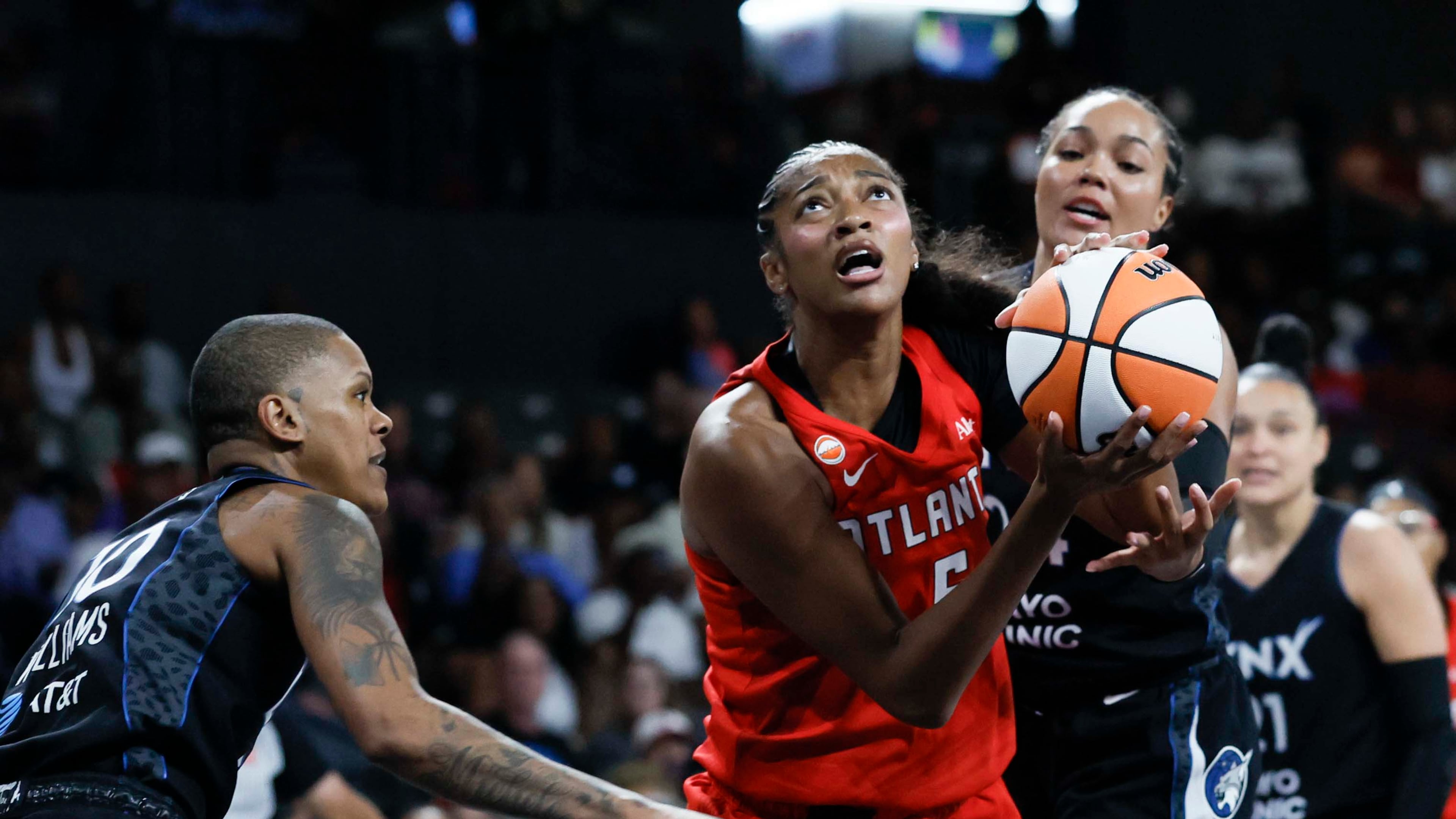 Atlanta Dream forward Angel Reese (center) goes up for a basket against Minnesota Lynx guard Courtney Williams (left) in the first half of a WNBA game at Gateway Center Arena on Sunday, Aug. 30, 2026, in Atlanta. (Miguel Martinez/ AJC)
