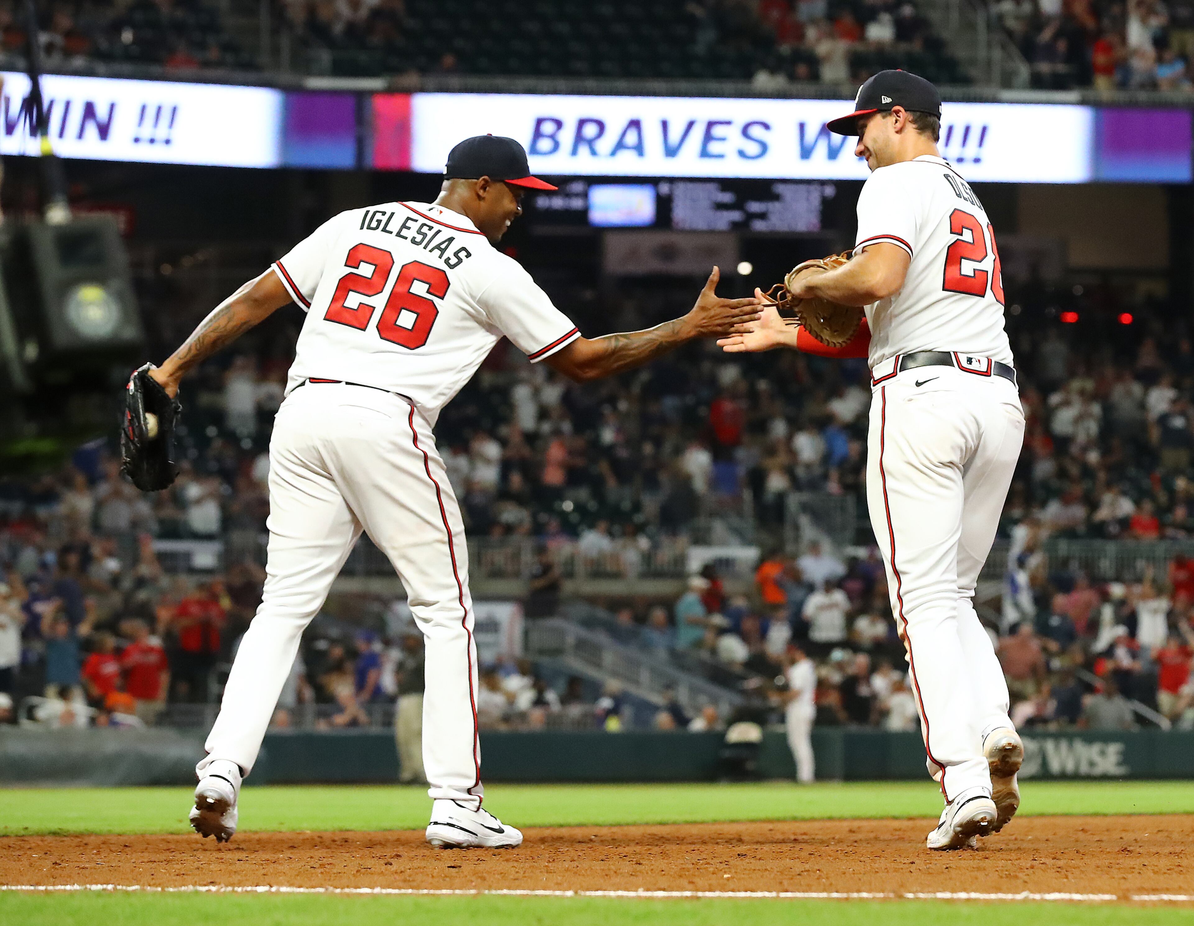 Braves closing pitcher Raisel Iglesias gives first baseman Matt Olson five after he made a play on a hot grounder down the first base line by New York Mets batter Francisco Lindo for the final out of the game during the ninth inning to seal a 5-0 shutout in a MLB baseball game on Tuesday, August 16, 2022, in Atlanta. “Curtis Compton / Curtis Compton@ajc.com