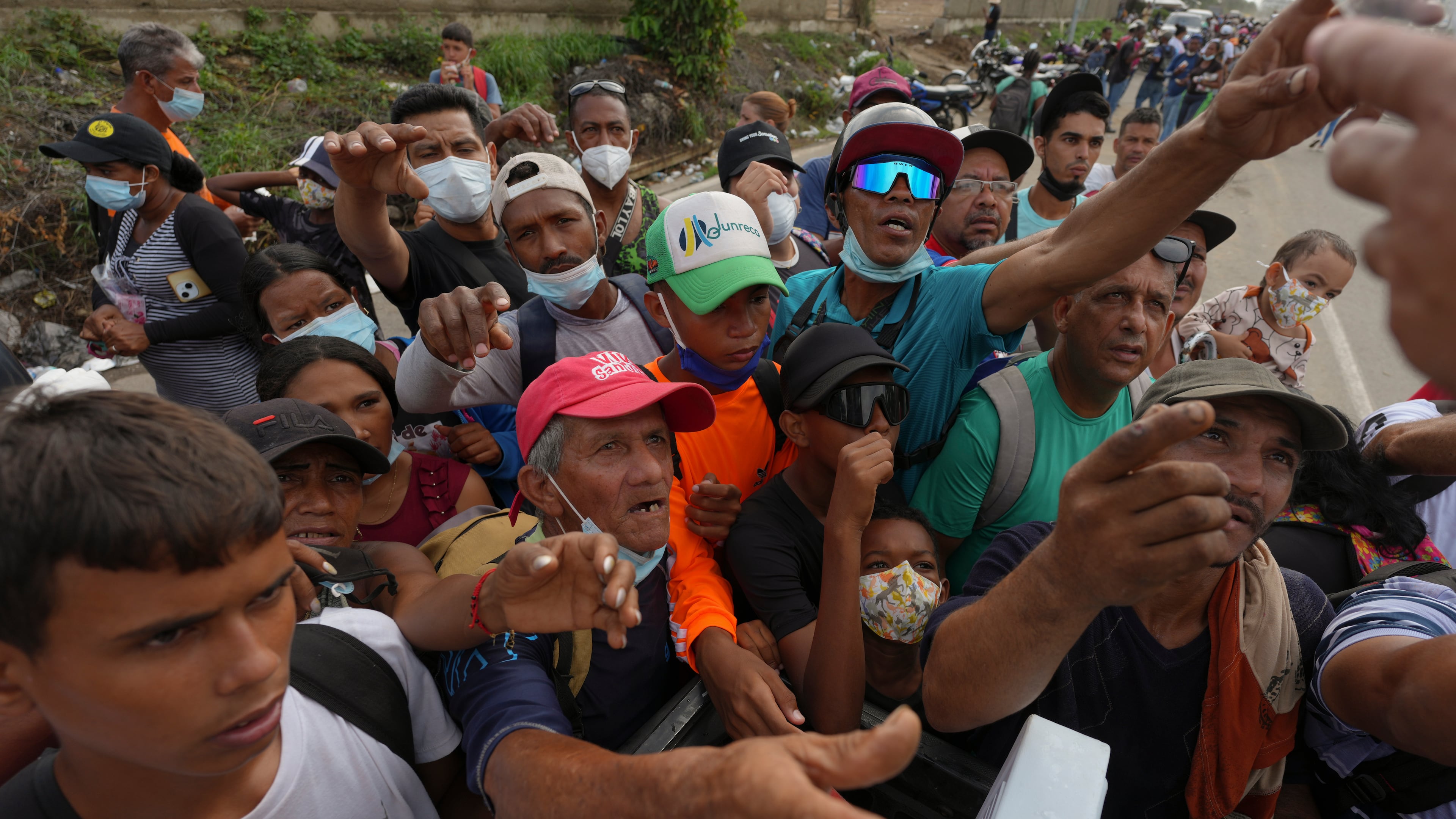 People reach out to receive supplies from volunteers, days after an earthquake struck La Guaira, Venezuela, Tuesday, June 30, 2026. (AP Photo/Matias Delacroix)