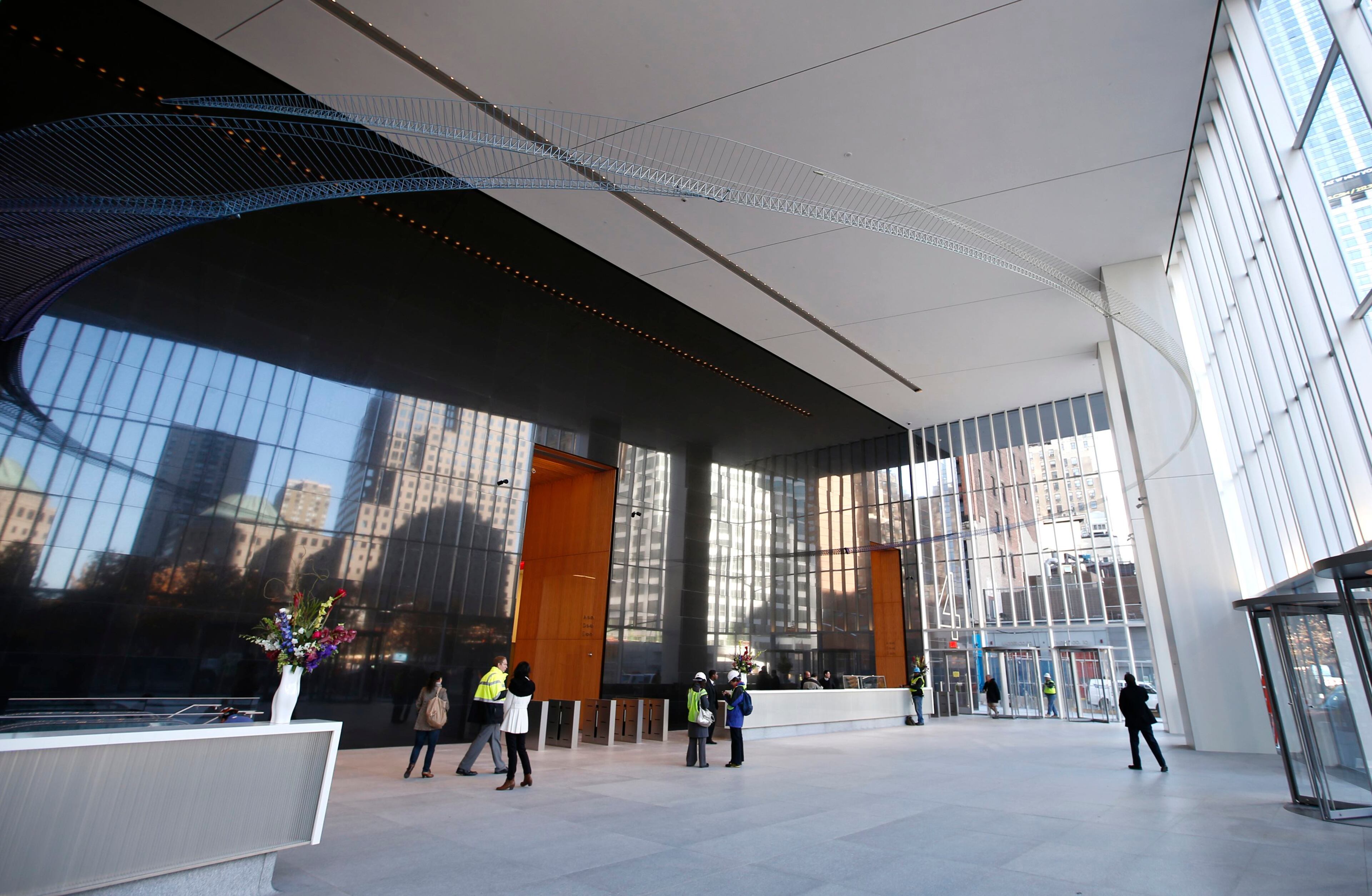 Workers put finishing touches in the lobby of the soon to be opened 4 World Trade Center tower in New York, November 8, 2013. 4 World Trade center sits at the south east corner of the World Trade Center site and will be the second tower to open on the site since the 2001 attacks on the World Trade Center. REUTERS/Mike Segar (UNITED STATES - Tags: BUSINESS CITYSCAPE)