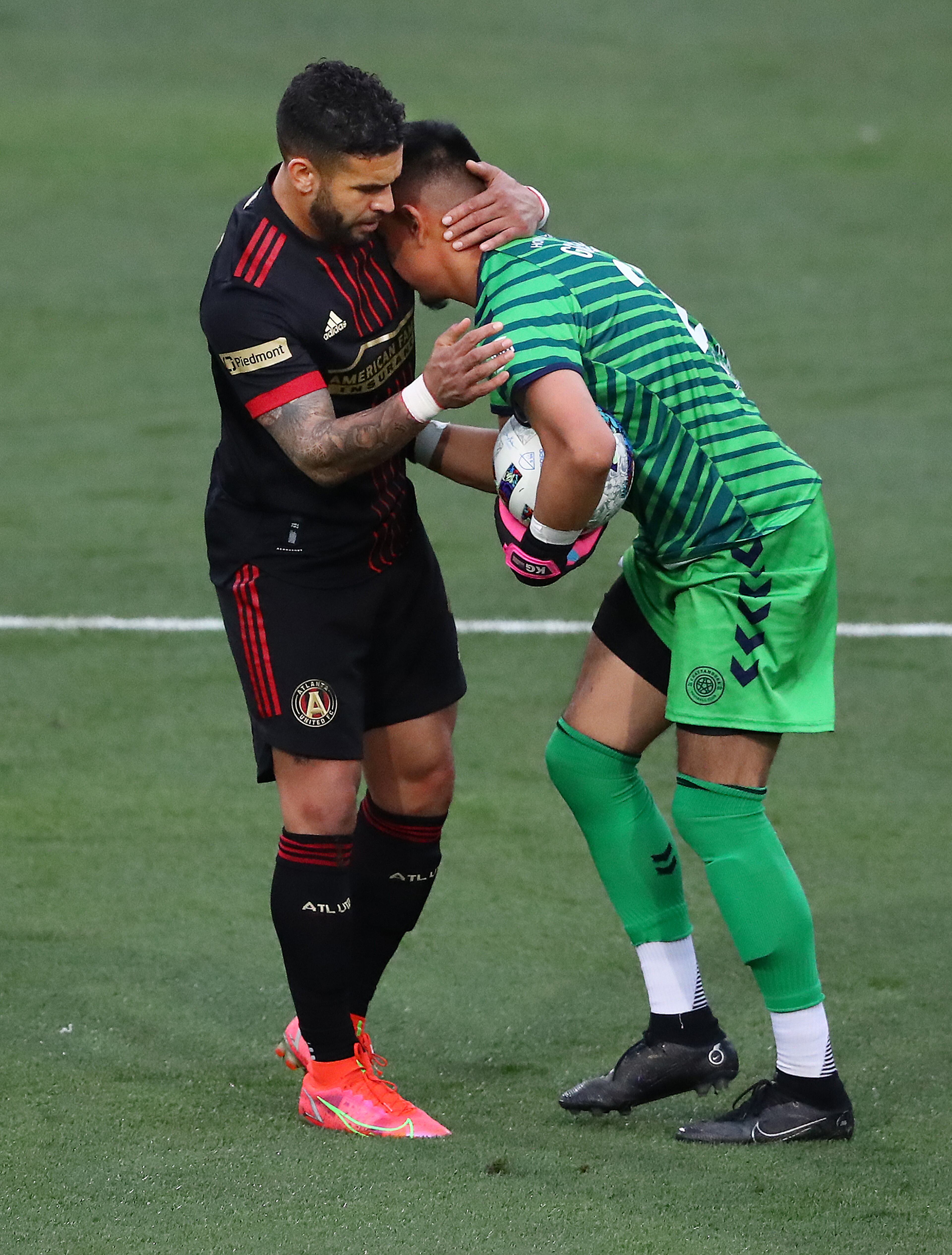 Atlanta United attacker Dom Dwyer gives Chattanooga FC goalkeeper Kevin Gonzalez a hug after helping him up on a collision with a show of sportsmanship during the Lamar Hunt U.S. Open Cup on Wednesday, April 20, 2022, in Kennesaw. Atlanta United won the game 6-0. Dwyer had two goals in the match. “Curtis Compton / Curtis.Compton@ajc.com”