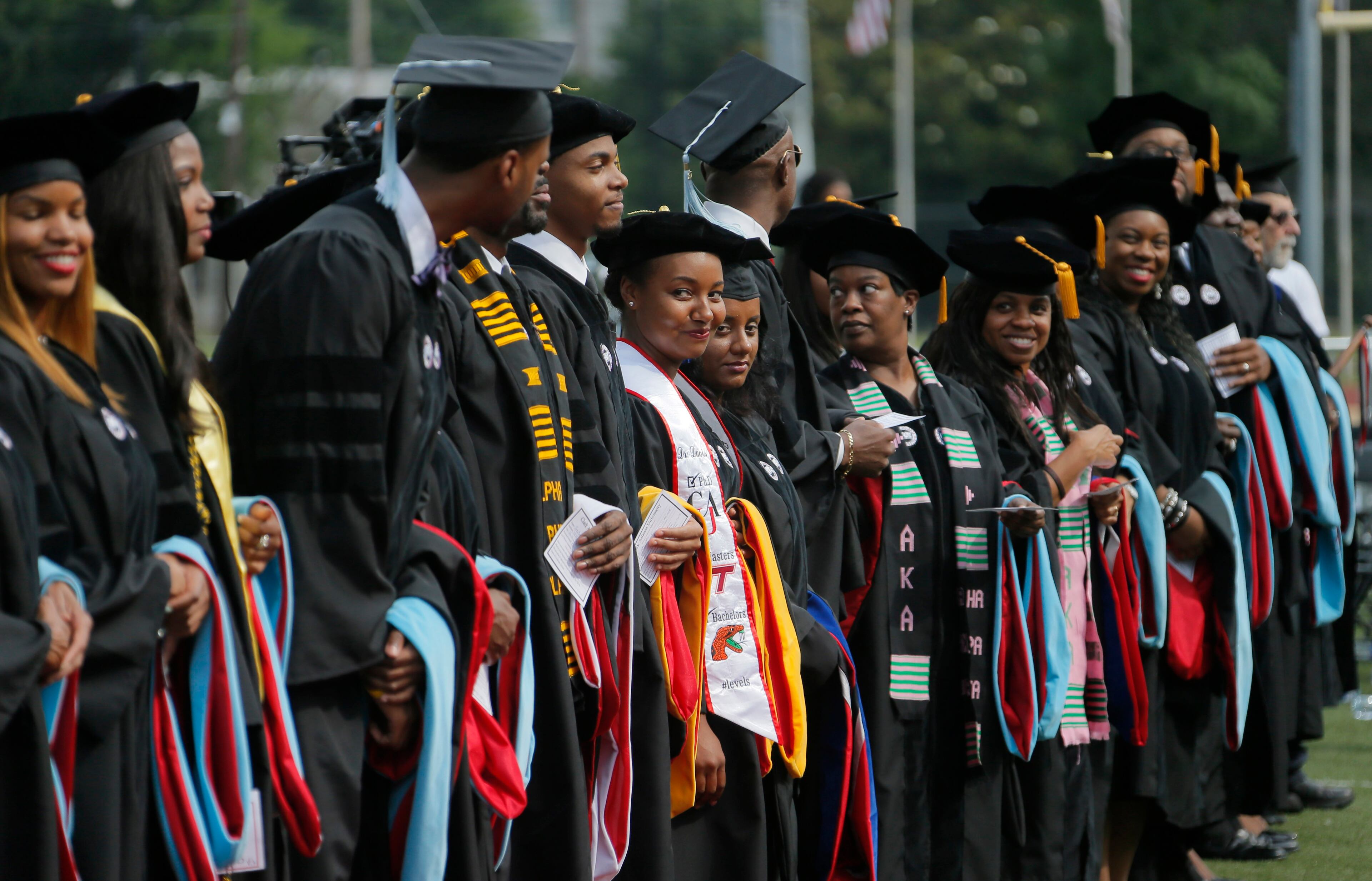 5/22/17 - Atlanta - Doctoral graduates line up to be hooded. Clark Atlanta University's Panther Stadium was the site of their 28th annual Commencement. Businessman William Pickard gave the commencement address. Rev. Jesse Jackson, who received an honorary degree, also spoke. Panther Stadium, BOB ANDRES /BANDRES@AJC.COM