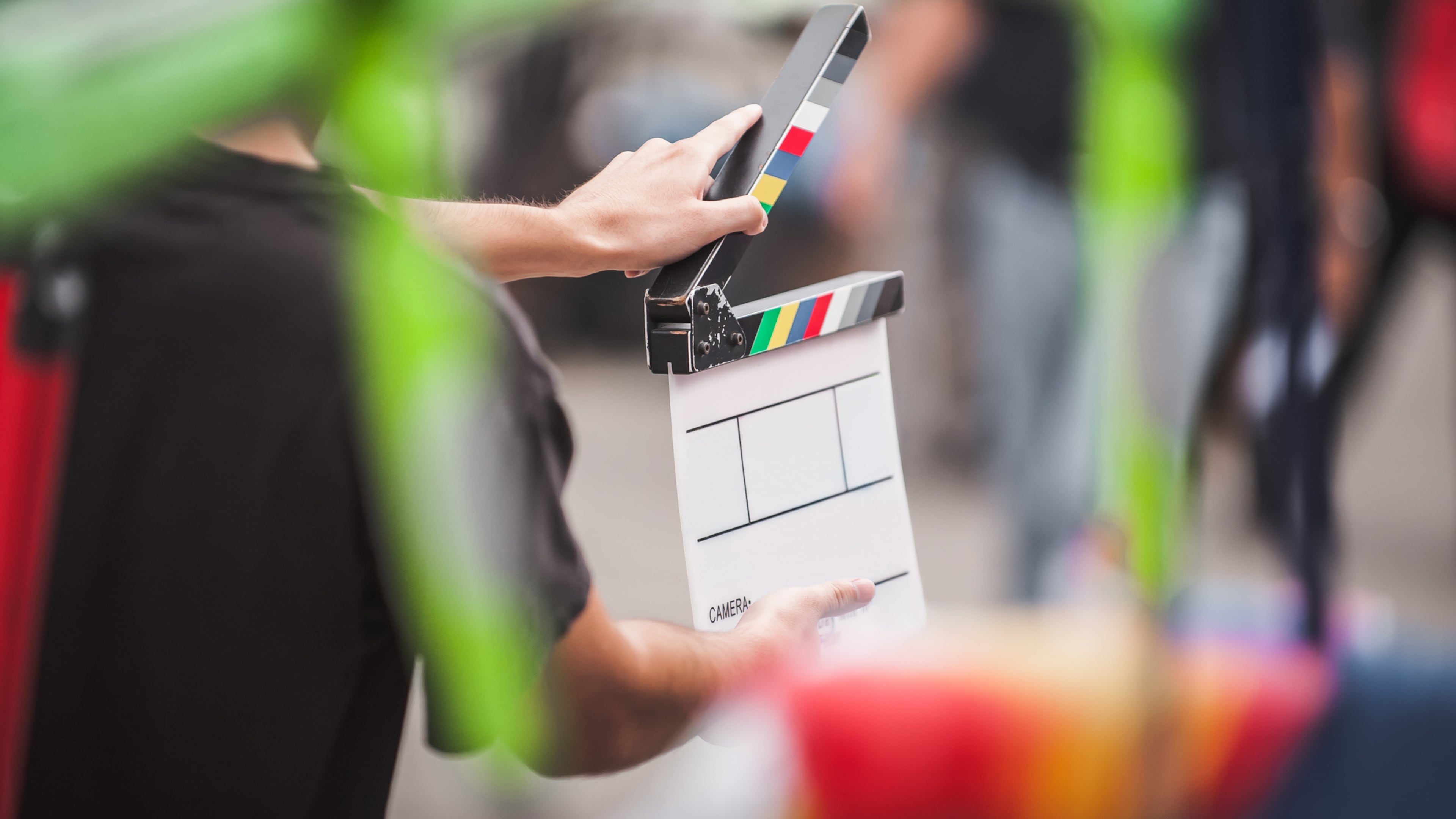 Filming on location. Man holding a clapperboard in front of the camera, the filming process. Scene on location