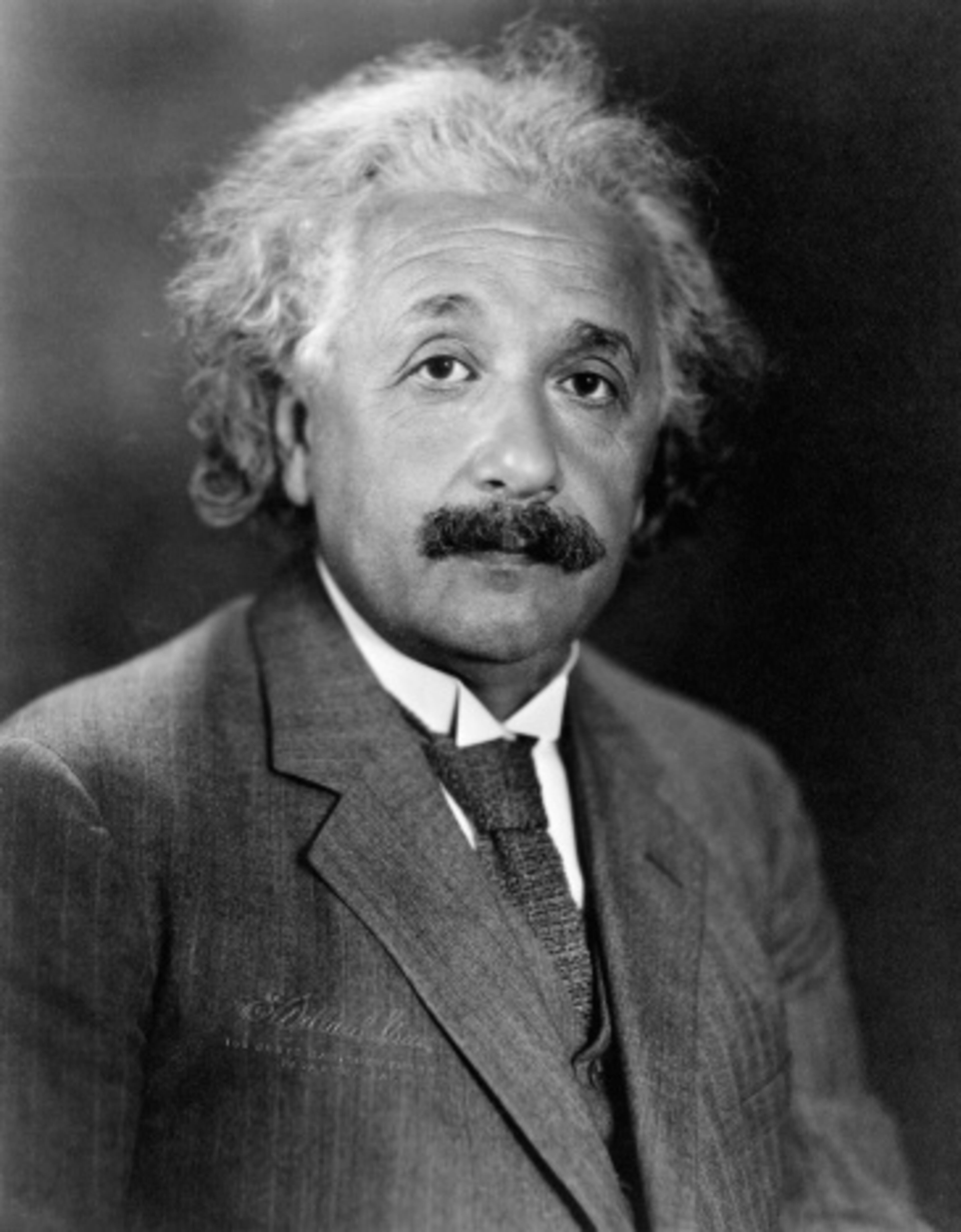 Albert Einstein is so smart his last name is synonymous with genius. The German-born theoretical physicist, who was visiting the United States when Hitler came to power and decided to stay, developed the general theory of relativity, one of the two pillars of modern physics. His general theory implied the existence of black holes. His special theory of relativity postulates there's no constant point of reference against which to measure motion and nothing with mass can exceed the speed of light. His mass–energy equivalence formula (Energy equals Mass times the Speed of Light squared) describes the huge amounts of energy released during nuclear reactions.