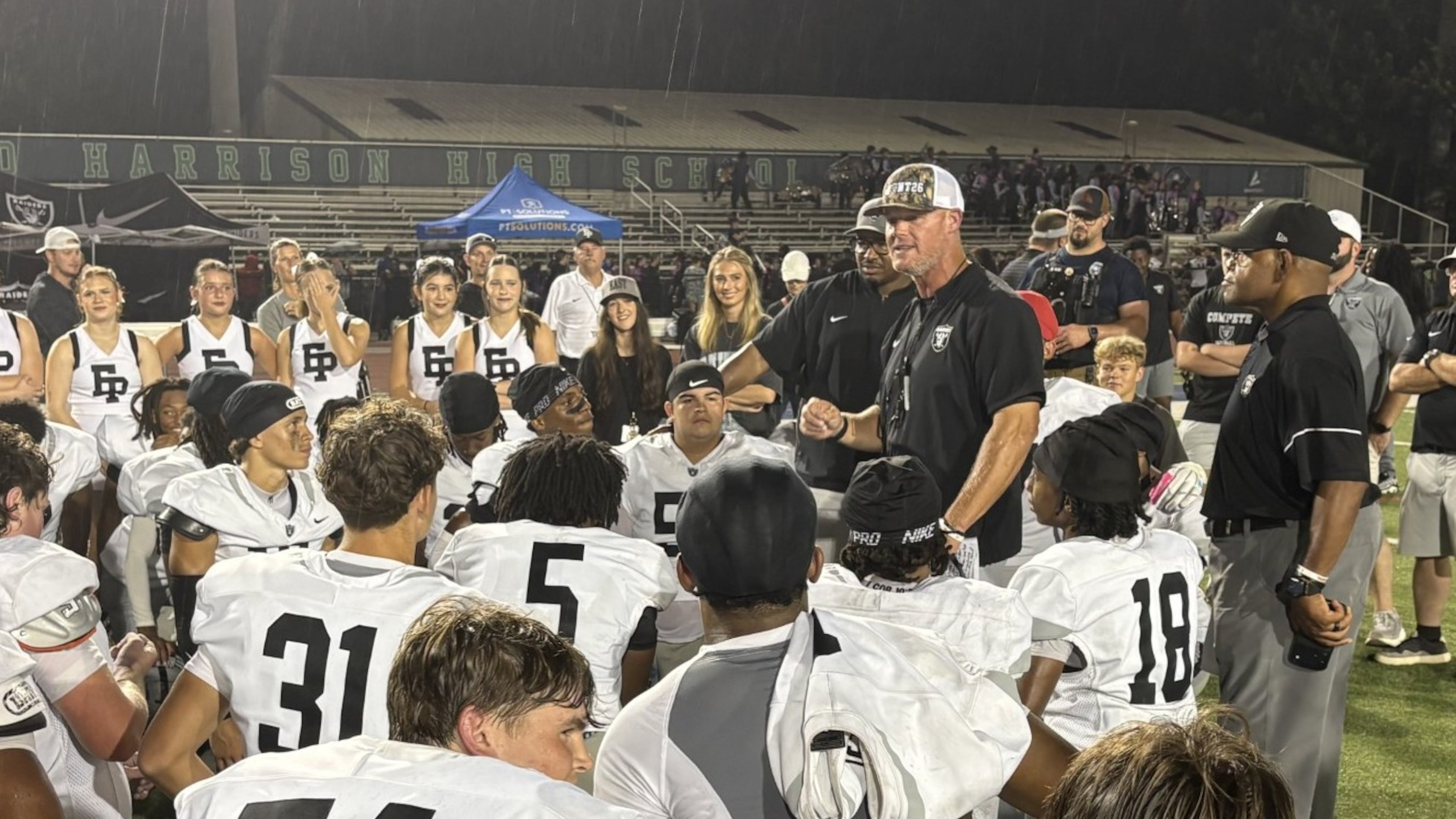 East Paulding coach Van Spence talks to his players after the Raiders' 27-23 victory over Harrison at Cobleigh Stadium on Aug. 28, 2026.