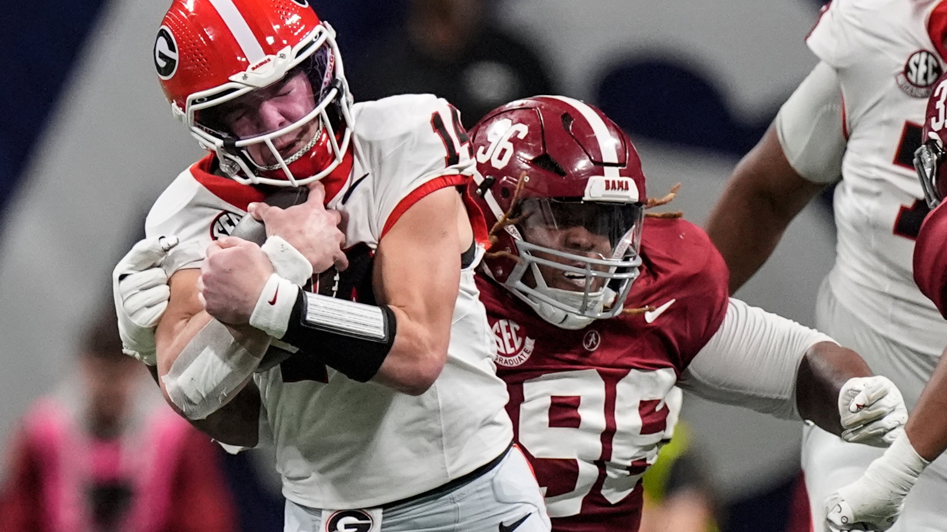 FILE - Georgia quarterback Gunner Stockton (14) runs against Alabama during the second half of a Southeastern Conference championship NCAA college football game in Atlanta, Dec. 6, 2025. (AP Photo/Mike Stewart, File)
