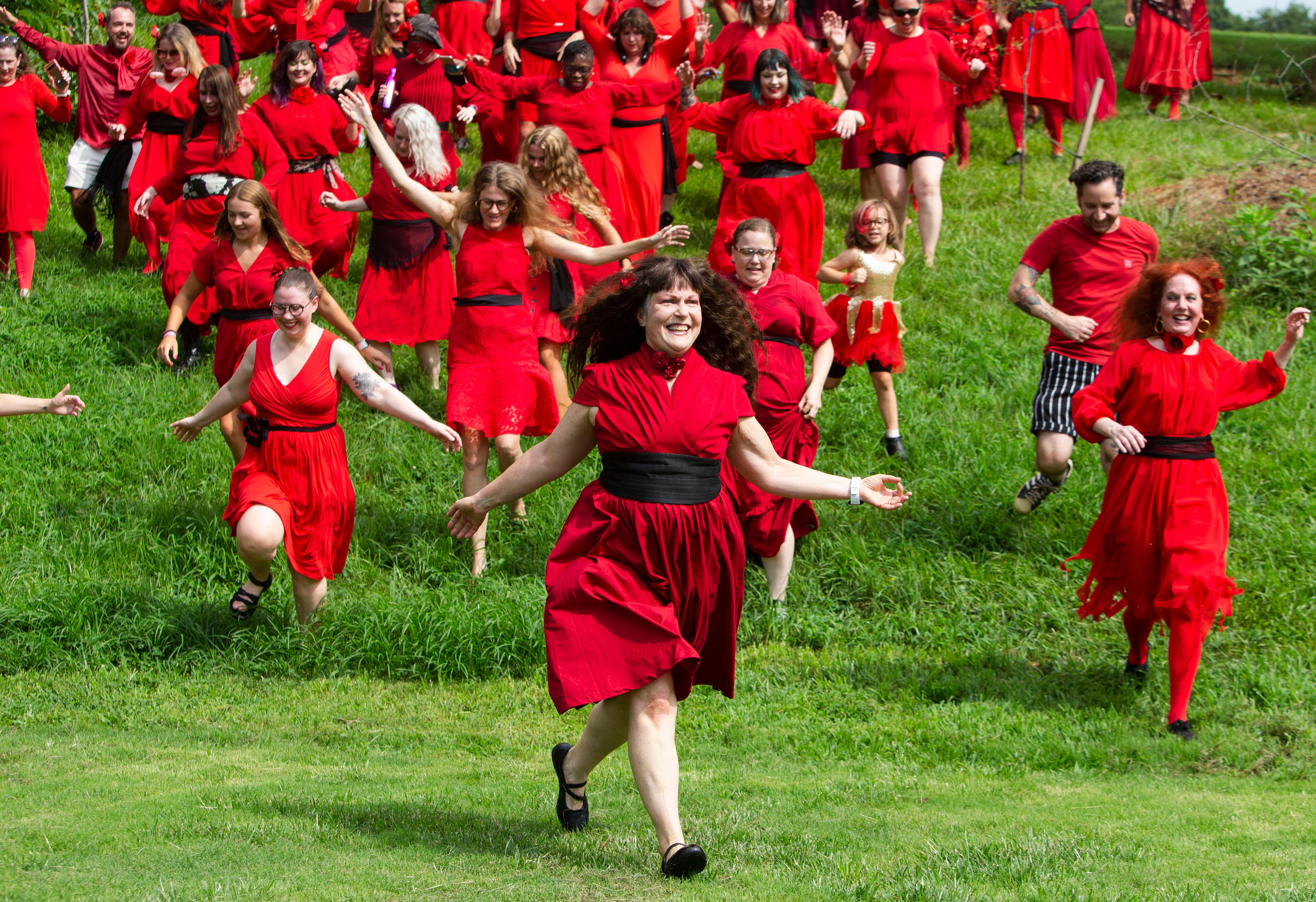 Lisa Bennett leads the pack of Kate Bush fans running down the hill after a group dance performance to celebrate the seventh annual international "Most Wuthering Heights Day Ever," on Saturday, July 30, 2022, in Candler Park in Atlanta. The event celebrates Kate Bush's 1978 song "Wuthering Heights" with events in more than 40 cities around the world. CHRISTINA MATACOTTA FOR THE ATLANTA JOURNAL-CONSTITUTION