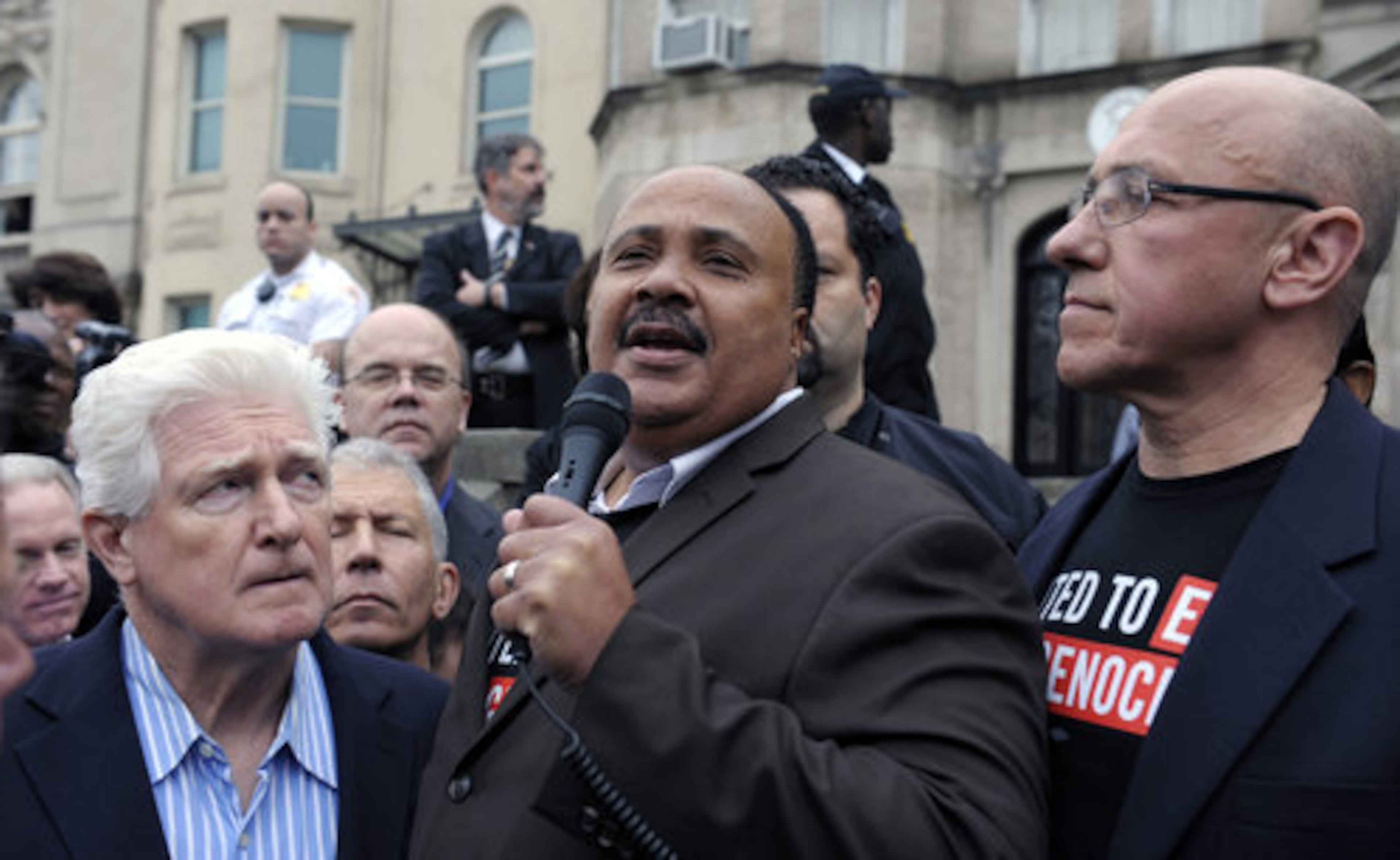 Martin Luther King, III, center, flanked by Rep. Jim Moran, D-Va., left, and Tom Andrews, president, United to End Genocide, speaks during the protest.