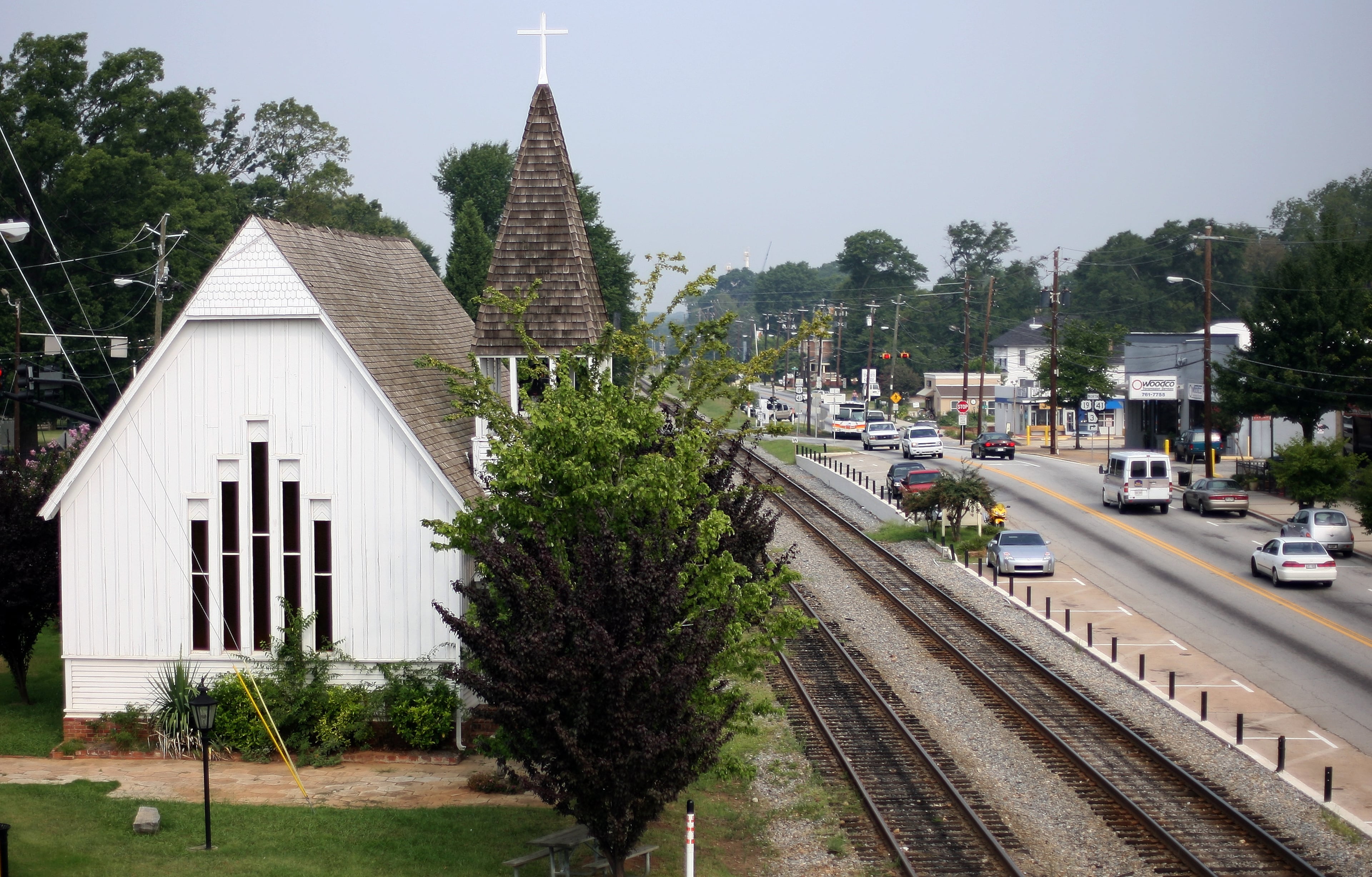 The Christ Church Building (at left) is the oldest standing church structure in the City of Hapeville. It has since been renovated and moved from its former location beside the train tracks (shown here in 2007) that bisect the city and is now offered to the public for exhibits, conventions, trade shows and other special events.