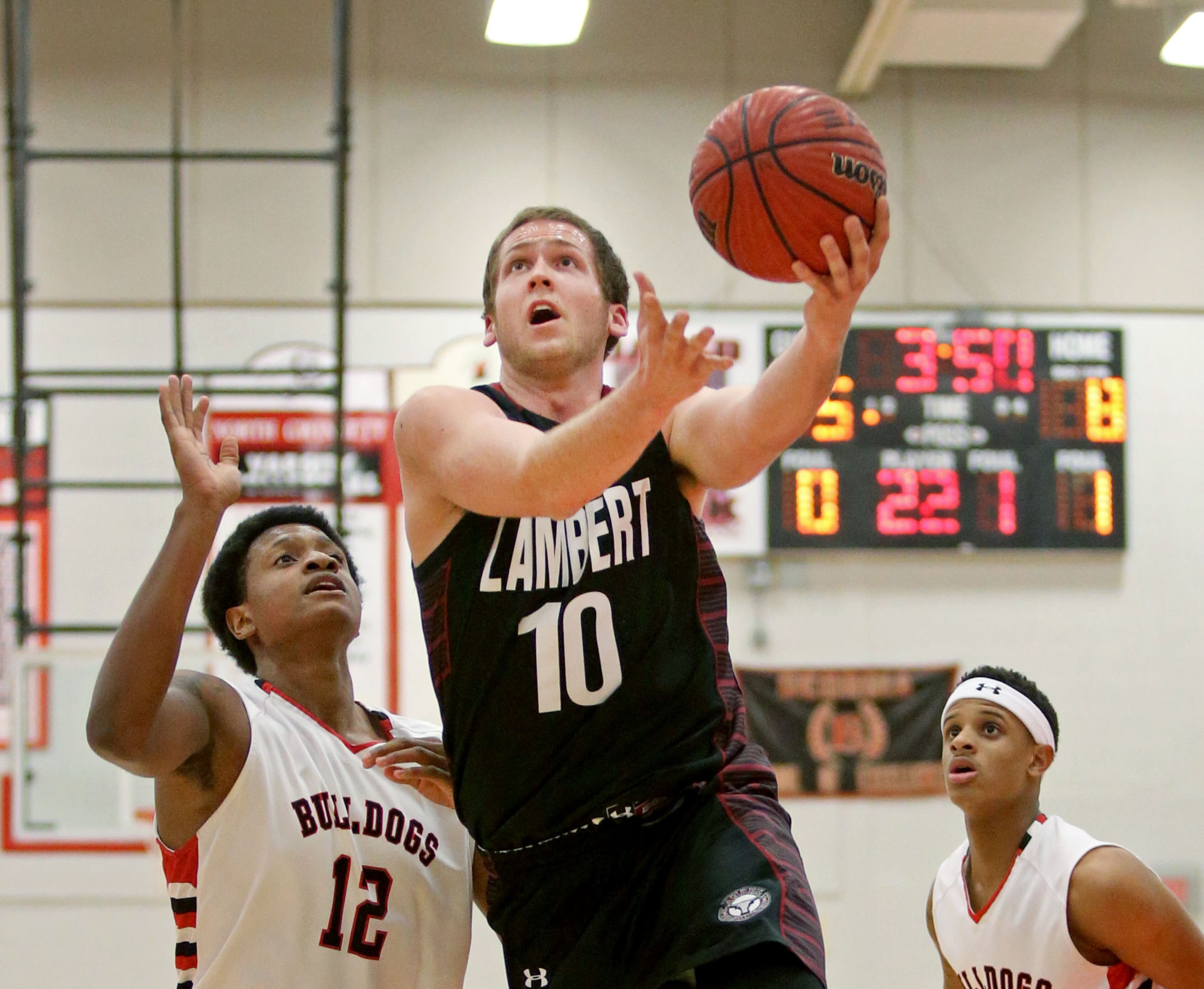 Lambert's Trevor Shipes (10) attempts a shot against North Gwinnett's Malik Carter, left, in their game Tuesday night in Suwanee, Ga., February 25, 2014. North Gwinnett defeated Lambert 74-48 in the second round of the Class AAAAAA state basketball tournament.
