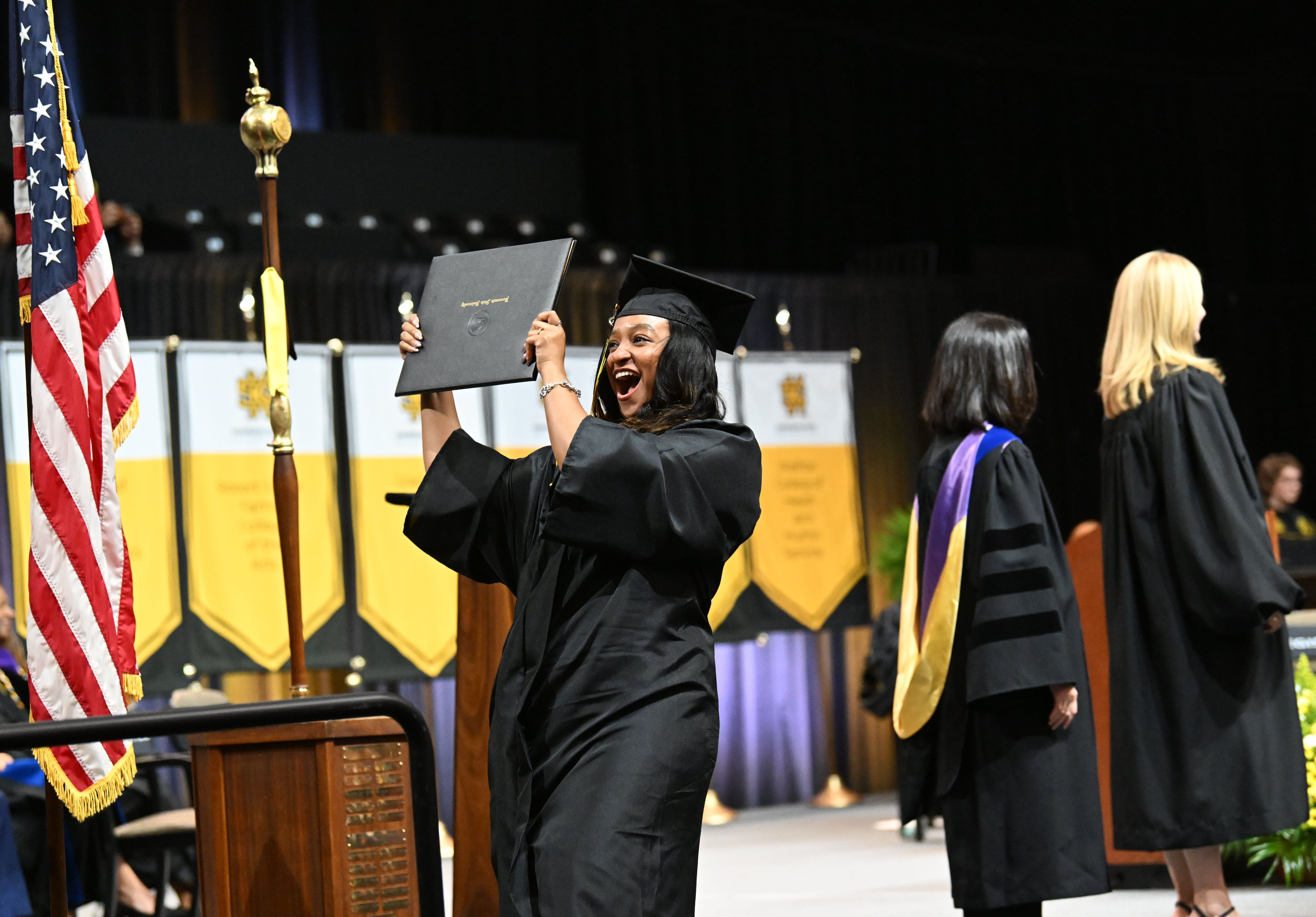 A graduate reacts as she receives her diploma during Kennesaw State University’s spring 2026 commencement. (Hyosub Shin/AJC)