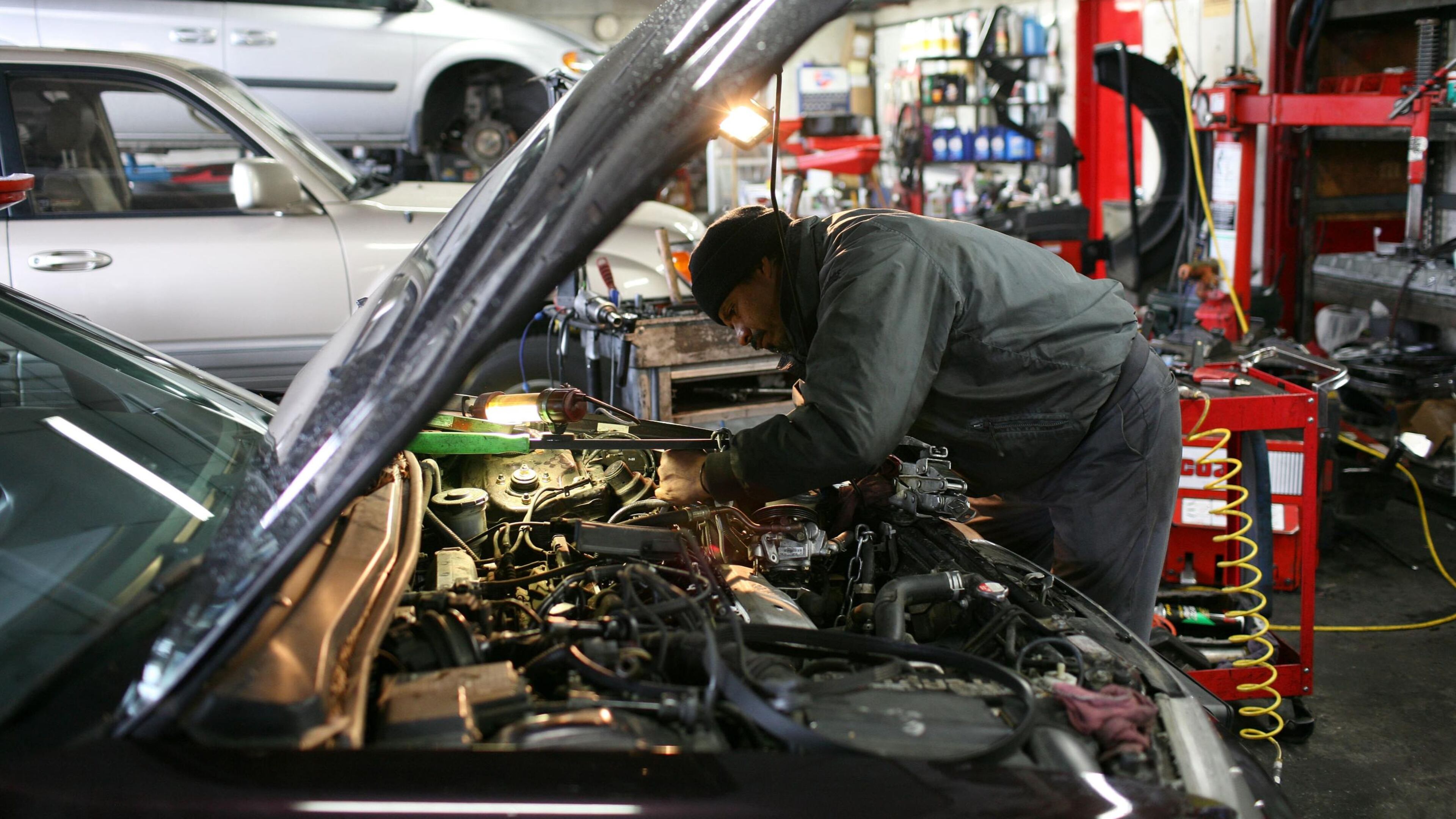 FILE PHOTO: A mechanic works on a car .