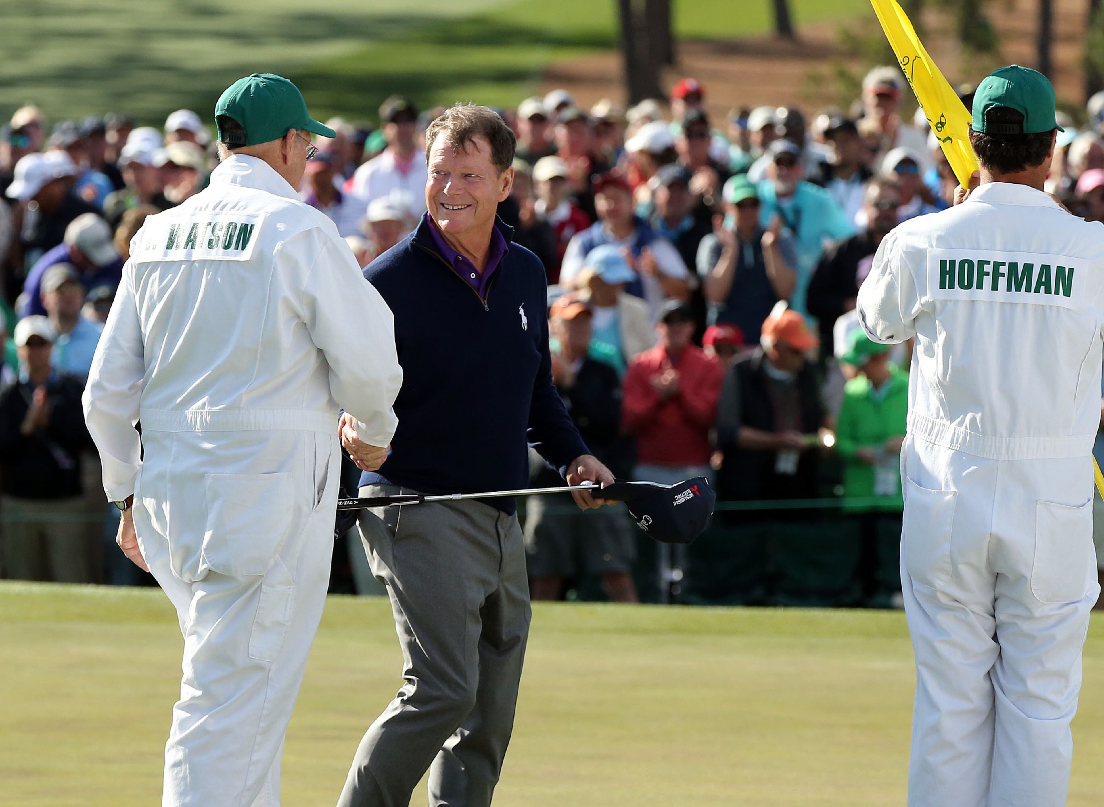 Tom Watson shakes hands with his caddie, Neil Oxman, as Brett Waldfman, caddie for Charley Hoffman, looks on at the 18th green during Watson's final Masters appearance in the second round of the 80th Masters at the Augusta National Golf Club, Friday, April 8, 2016. Curtis Compton/ccompton@ajc.com