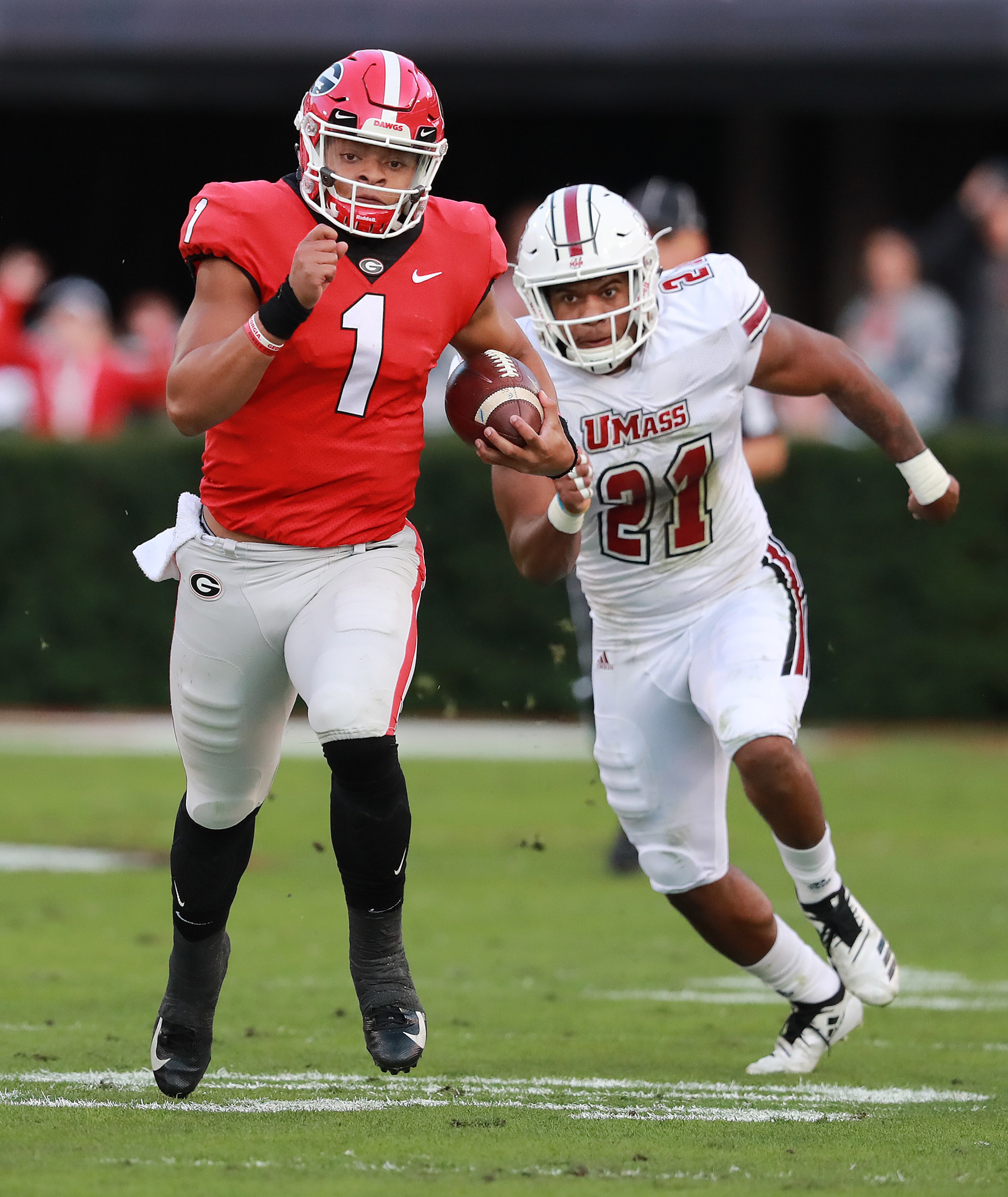 Nov 17, 2018 Athens: Georgia quarterback Justin Fields breaks away from Massachusetts defender Tyshaun Ingram for a 47-yard gain during the first quarter in a NCAA college football game on Saturday, Nov. 17, 2018, in Athens. Curtis Compton/ccompton@ajc.com