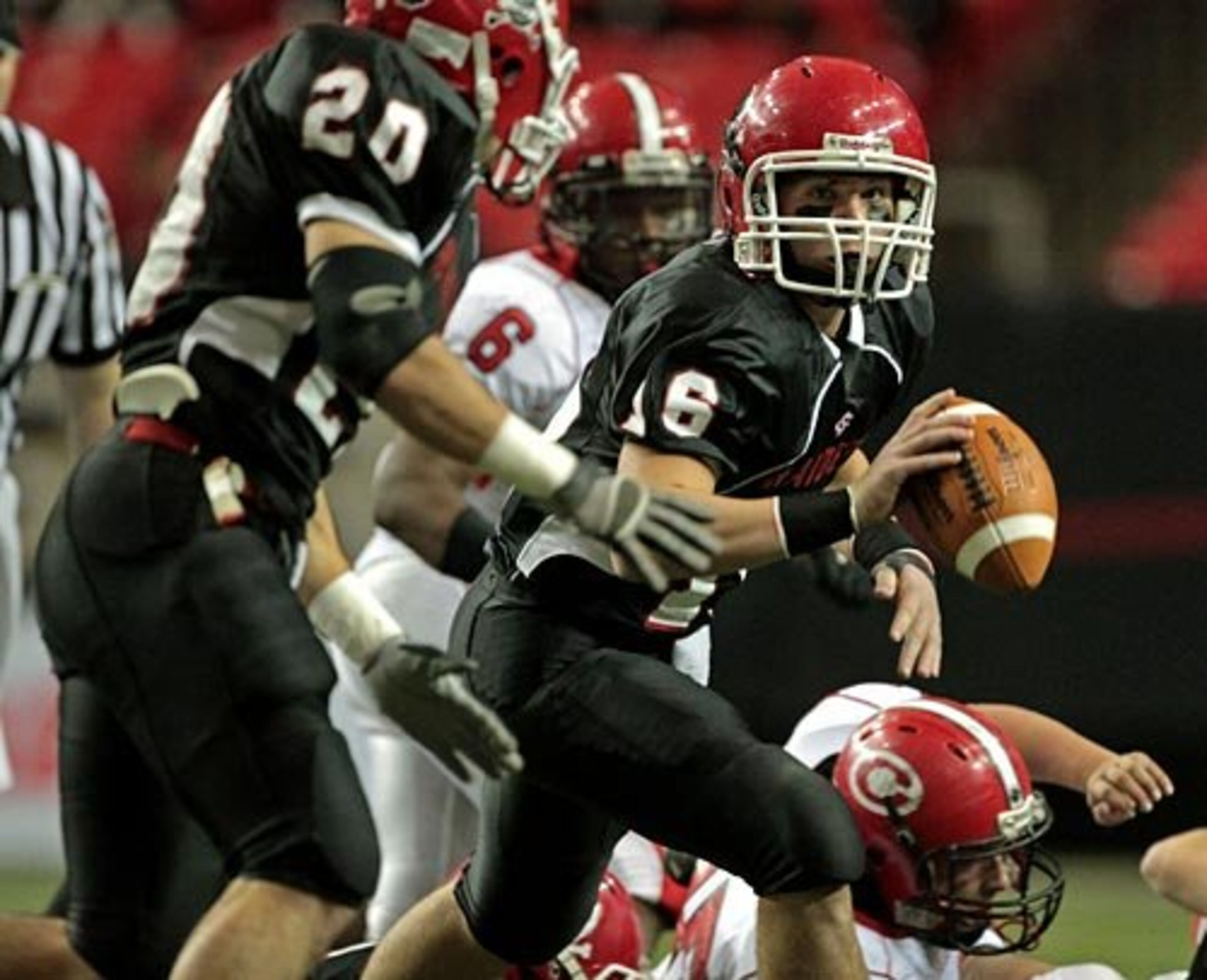 Savannah Christian quarterback Harrison Curry (facing) pitches the ball to running back Will Austin.