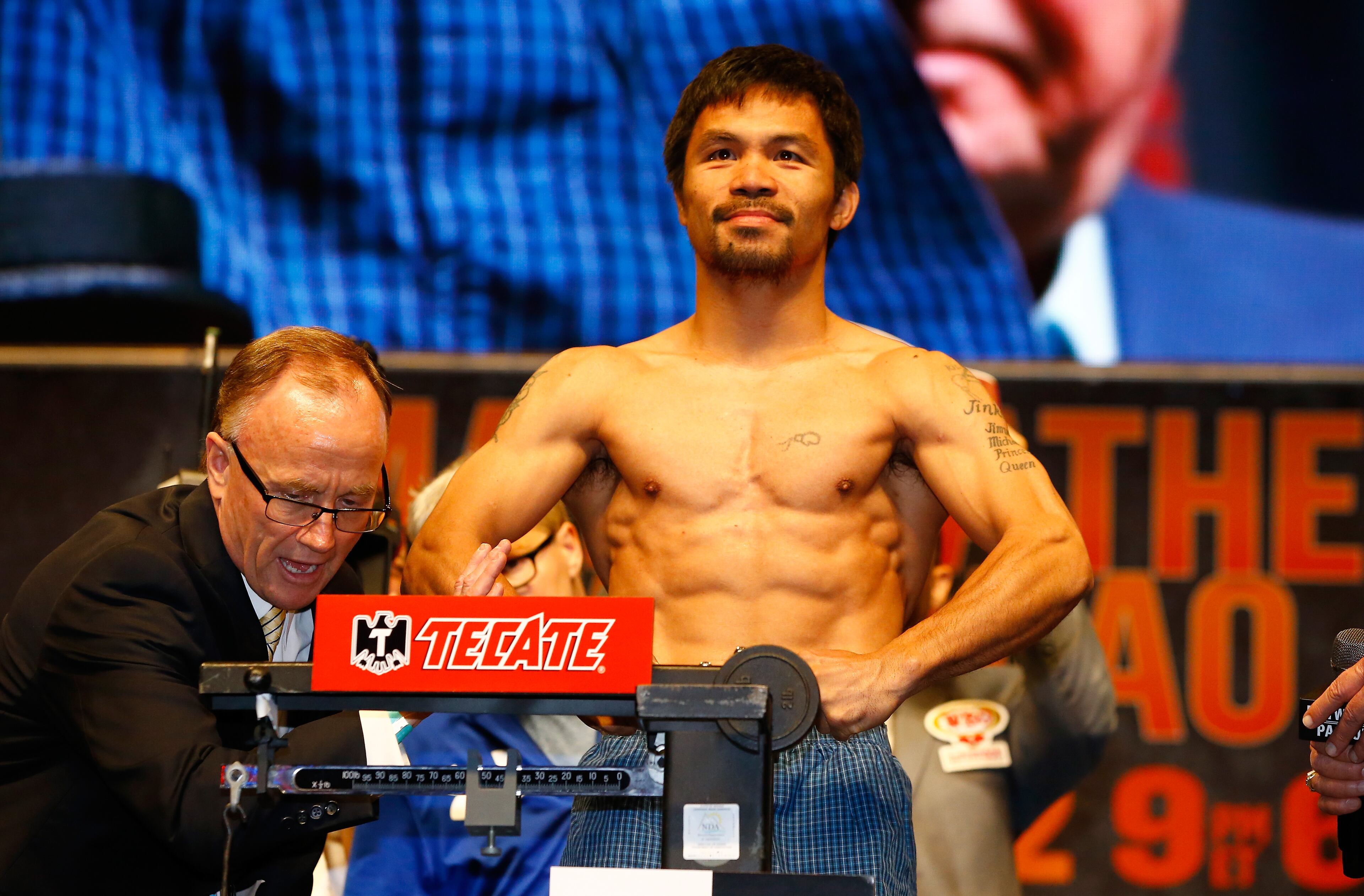 LAS VEGAS, NV - MAY 01: Manny Pacquiao poses on the scale during his official weigh-in on May 1, 2015 at MGM Grand Garden Arena in Las Vegas, Nevada. Pacquiao will face Floyd Mayweather Jr. in a welterweight unification bout on May 2, 2015 in Las Vegas. (Photo by Al Bello/Getty Images)