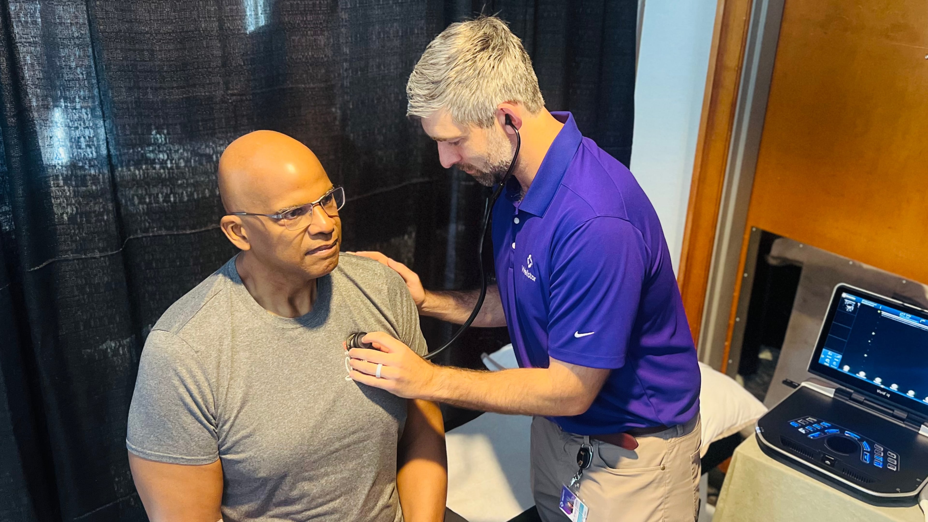 Dr. Connor O'Sullivan examines former Atlanta Falcons player and NFL retiree Philip McKinnely at NFL health screening in Atlanta on Saturday, April 18, 2026. (Courtesy of Wellstar Health System)