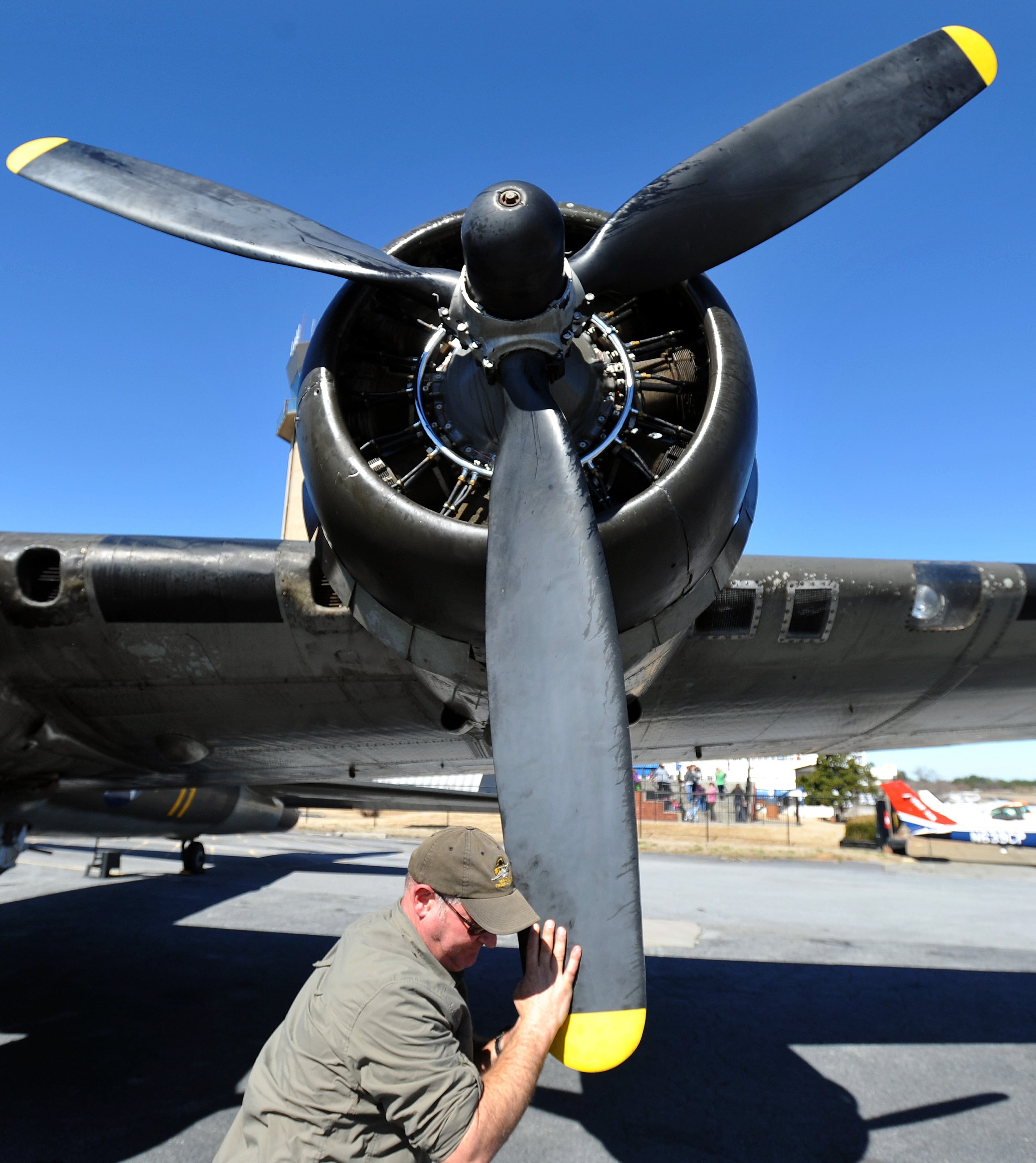 Crew member Travis Reynolds cycles one of the four Wright Cyclone radial engines during a preflight for the restored WWII-era B-17 Flying Fortress nicknamed the "Movie Memphis Belle," at DeKalb-Peachtree Airport on Monday, Feb. 24, 2014, in Atlanta. According to the Liberty Foundation, based in Douglas, crews dropped more than 640,000 tons of bombs over European targets from the bellies of the infamous bombers. For more information on tours, go to www.libertyfoundation.org. (AP Photo/David Tulis)