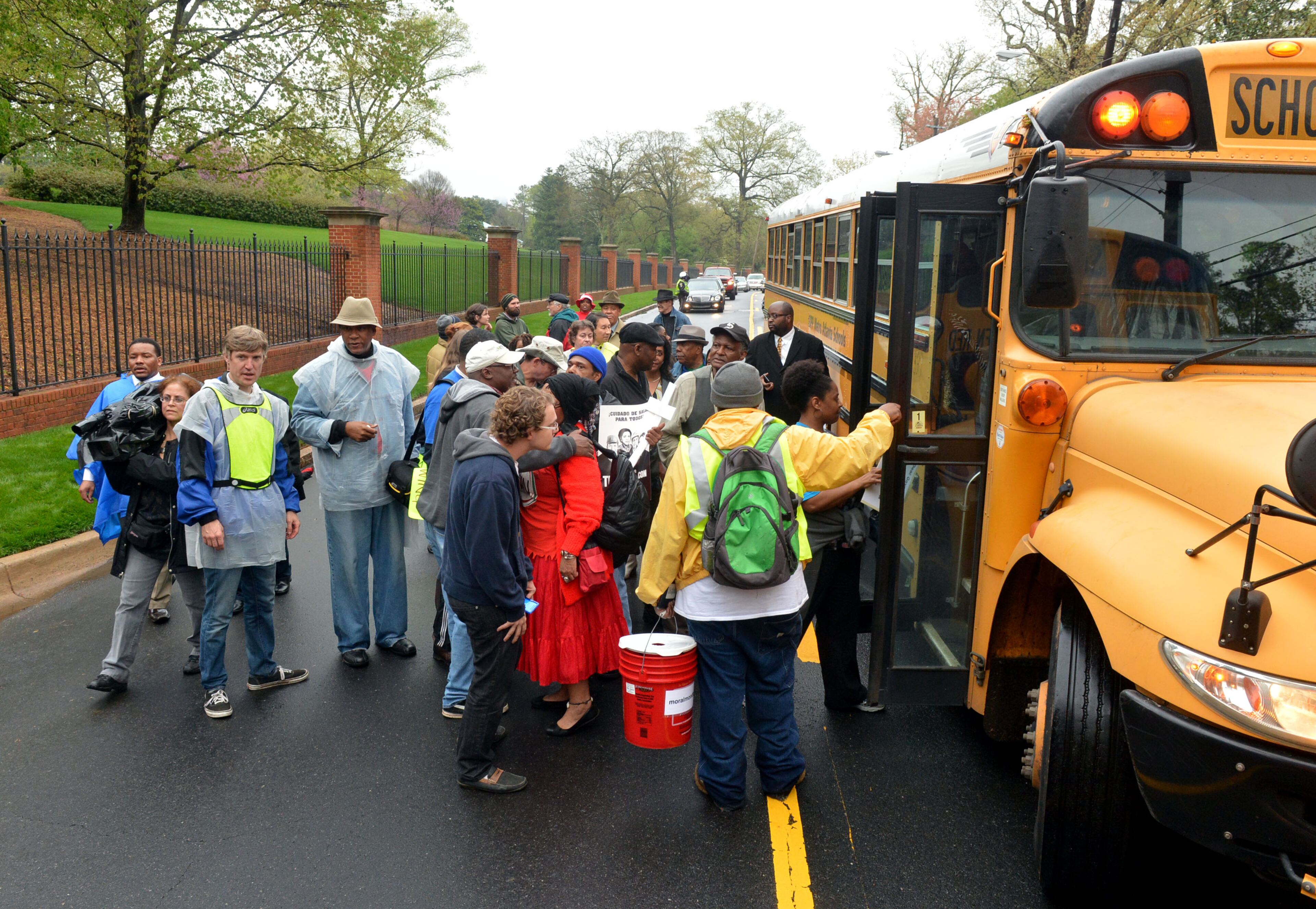 Protesters board buses following the conclusion of the Moral Monday demonstration for Medicaid expansion outside the Governor's Mansion on W. Paces Ferry Road Monday, April 7, 2014. KENT D. JOHNSON / KDJOHNSON@AJC.COM