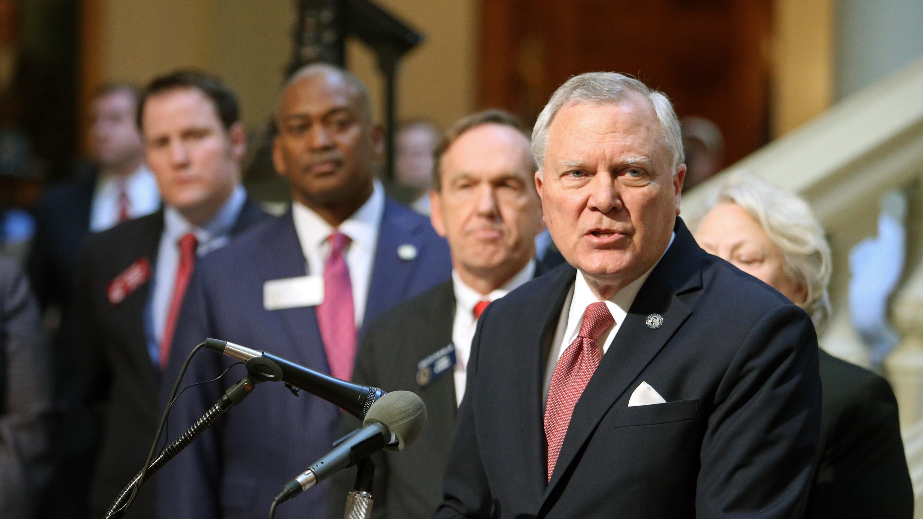 With several of the DeKalb delegation behind him, Gov. Nathan Deal announces that he'll remove all six DeKalb school board members at a new conference at the west wing of the Capitol Monday afternoon in Atlanta, Ga., February 25, 2013. JASON GETZ / JGETZ@AJC.COM