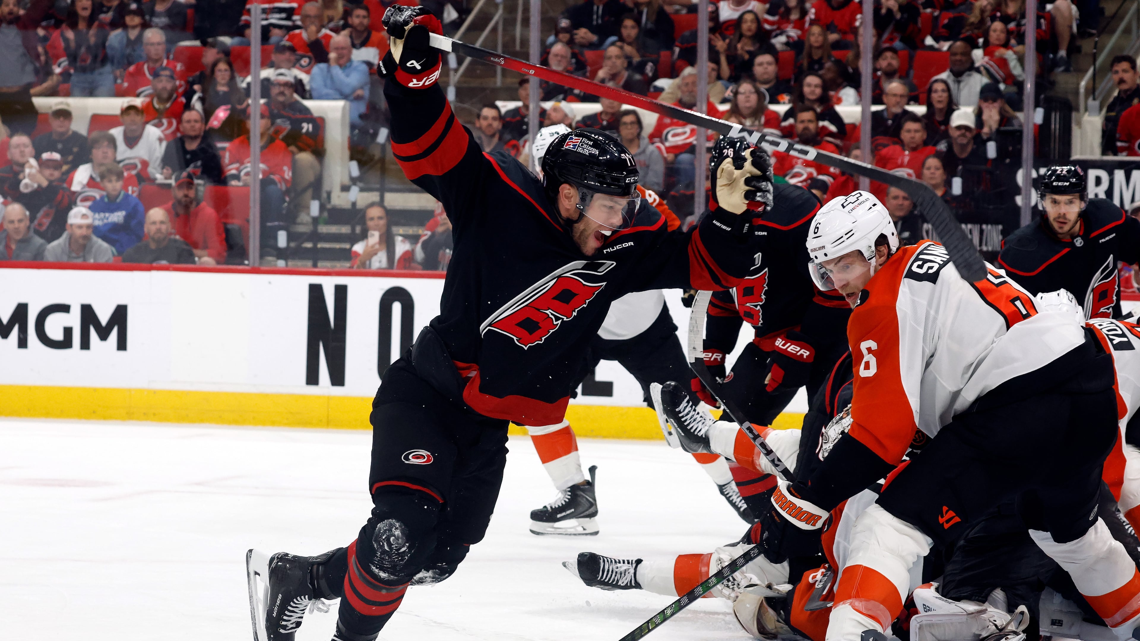 Carolina Hurricanes' Taylor Hall, left, celebrates after his winning overtime goal as Philadelphia Flyers' Travis Sanheim (6) looks on during Game 2 of an NHL hockey Stanley Cup second-round playoff series in Raleigh, N.C., Monday, May 4, 2026. (AP Photo/Karl DeBlaker)