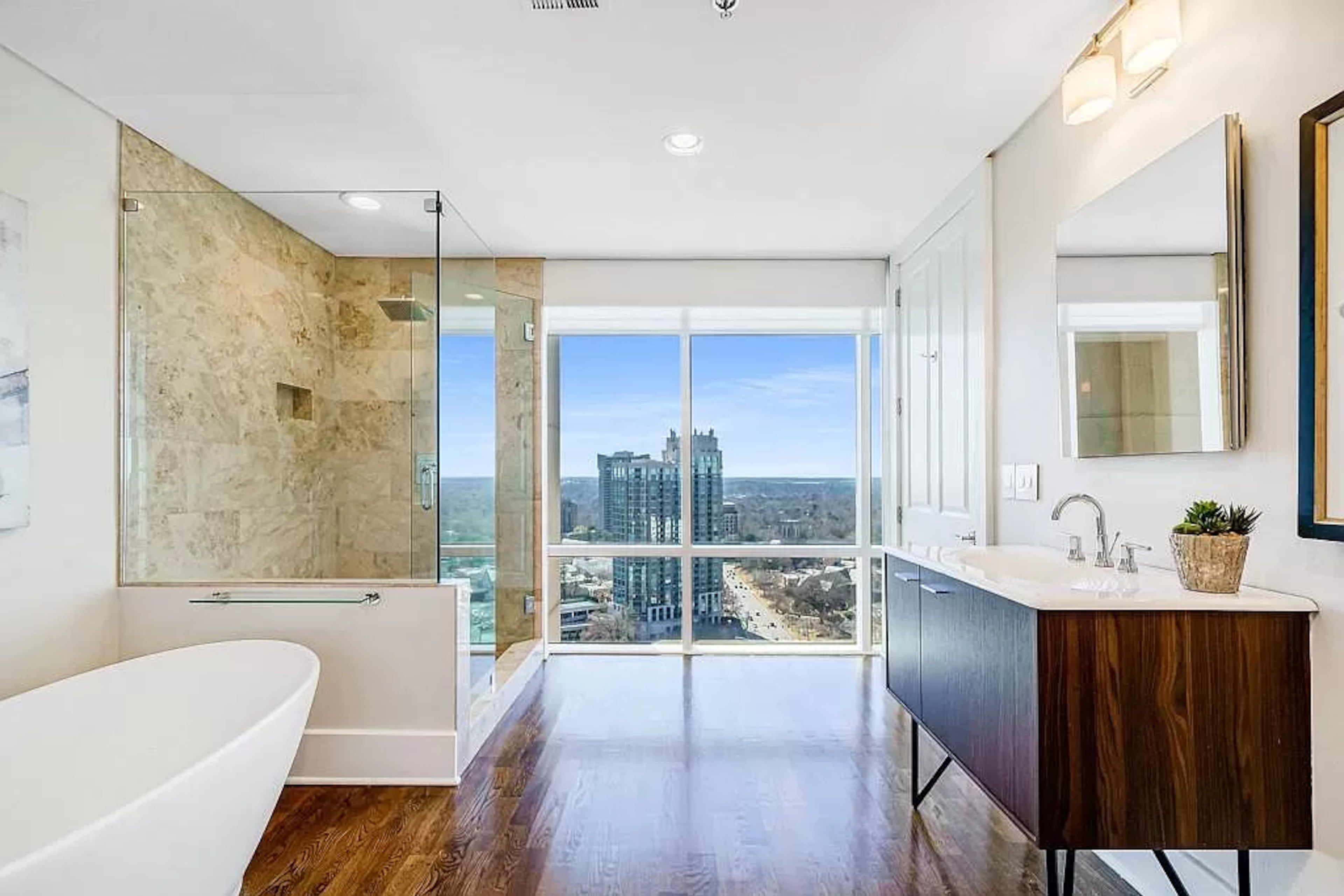Unwind at the end of the day by taking in the twinkling city lights from the bathroom’s floor-to-ceiling windows.